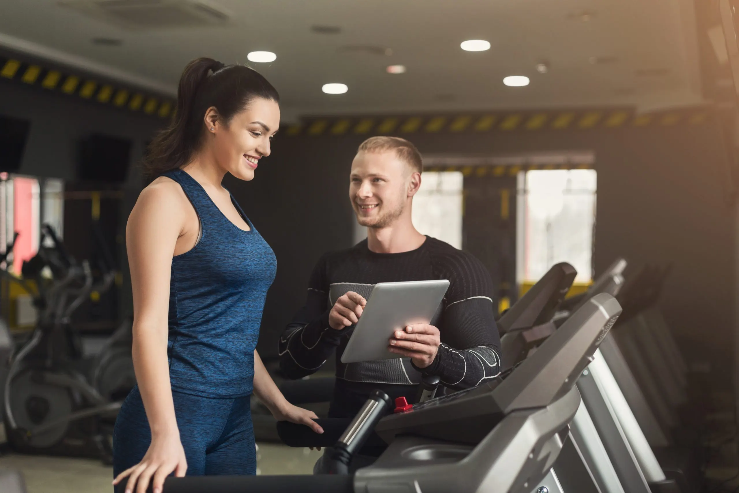 Vietnam health and fitness services Market Outlook to 2035 fitness-instructor-helps-young-woman-elliptical-trainer-coach-discussing-workout-plan-with-girl-treadmill-cardio-workout-gym-healthy-lifestyle-copy-space-scaled