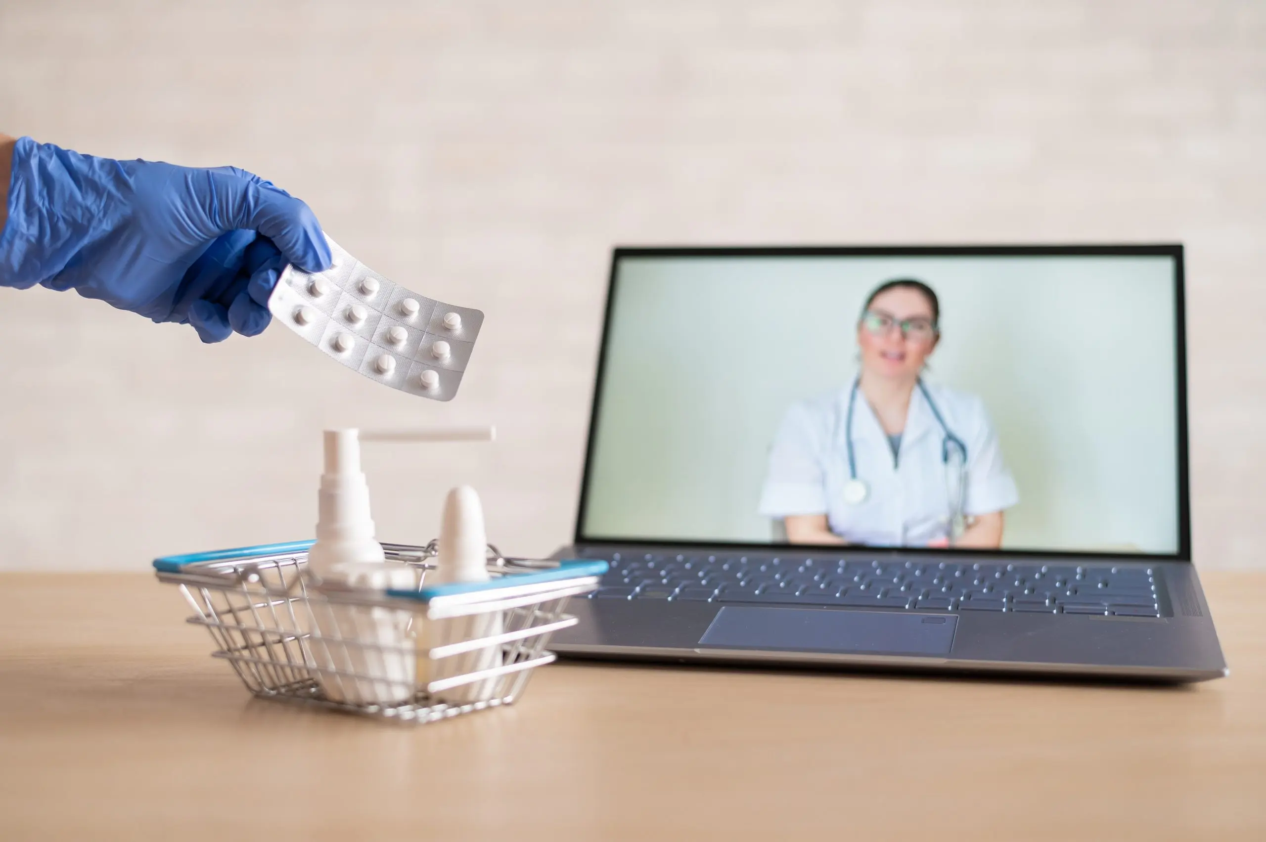 UK Telemedicine Market Size Expanding as Virtual Consultations Grow by 20% Yearly friendly-doctor-conducts-online-consultation-laptop-gloved-pharmacist-puts-medicine-into-mini-shopping-cart-concept-distance-medicine-order-drugs-online-scaled