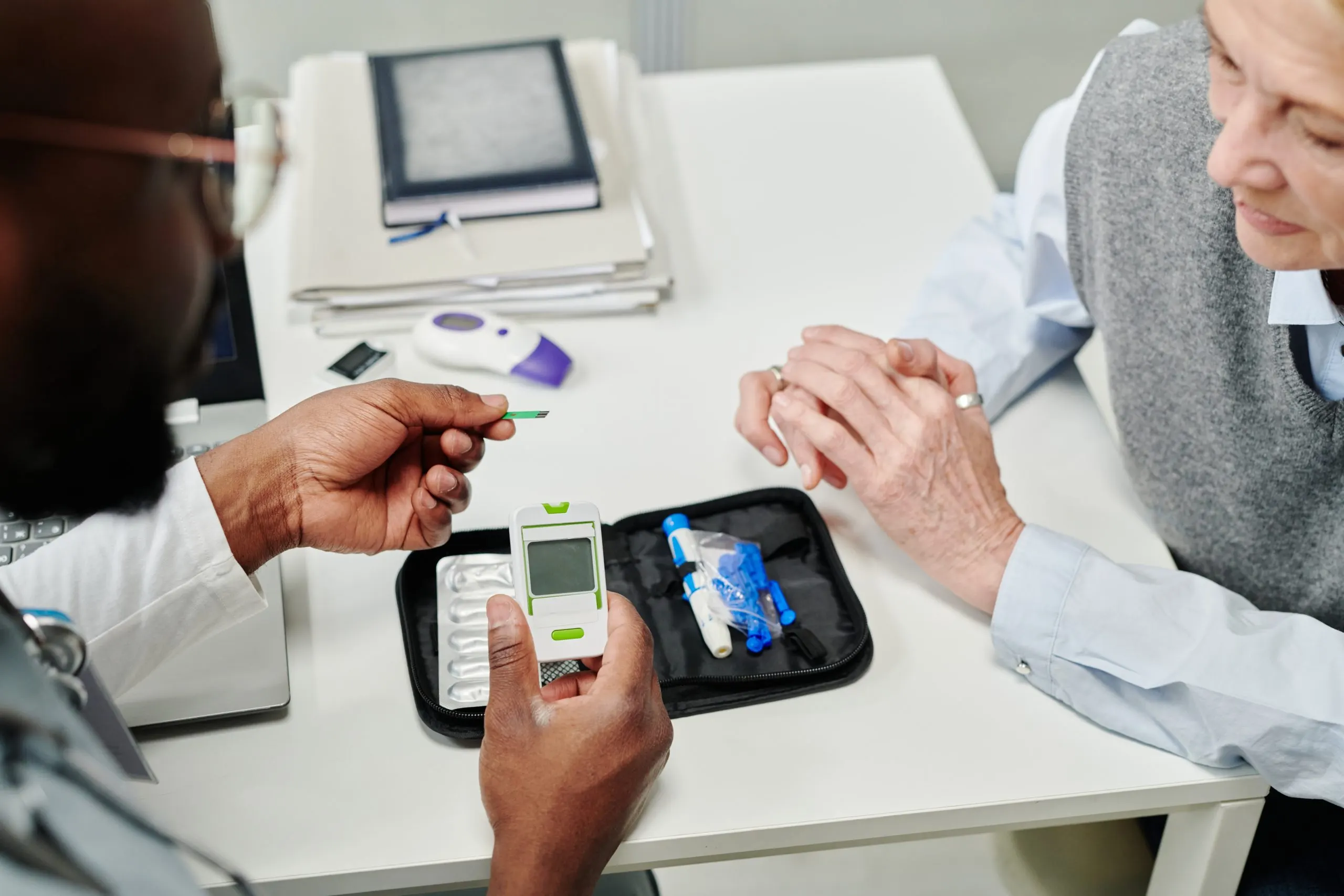 KSA Continuous Glucose Monitoring Systems Market Outlook 2035 hands-young-african-american-doctor-showing-mature-patient-glucometer-scaled