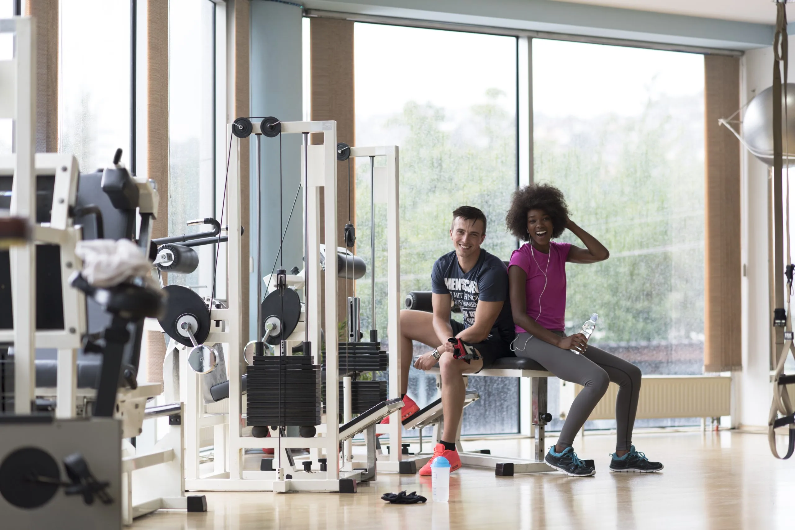 India Home Fitness Equipment Market Outlook to 2035 healthy-couple-have-break-crossfit-gym-african-american-woman-with-afro-hairstyle-scaled