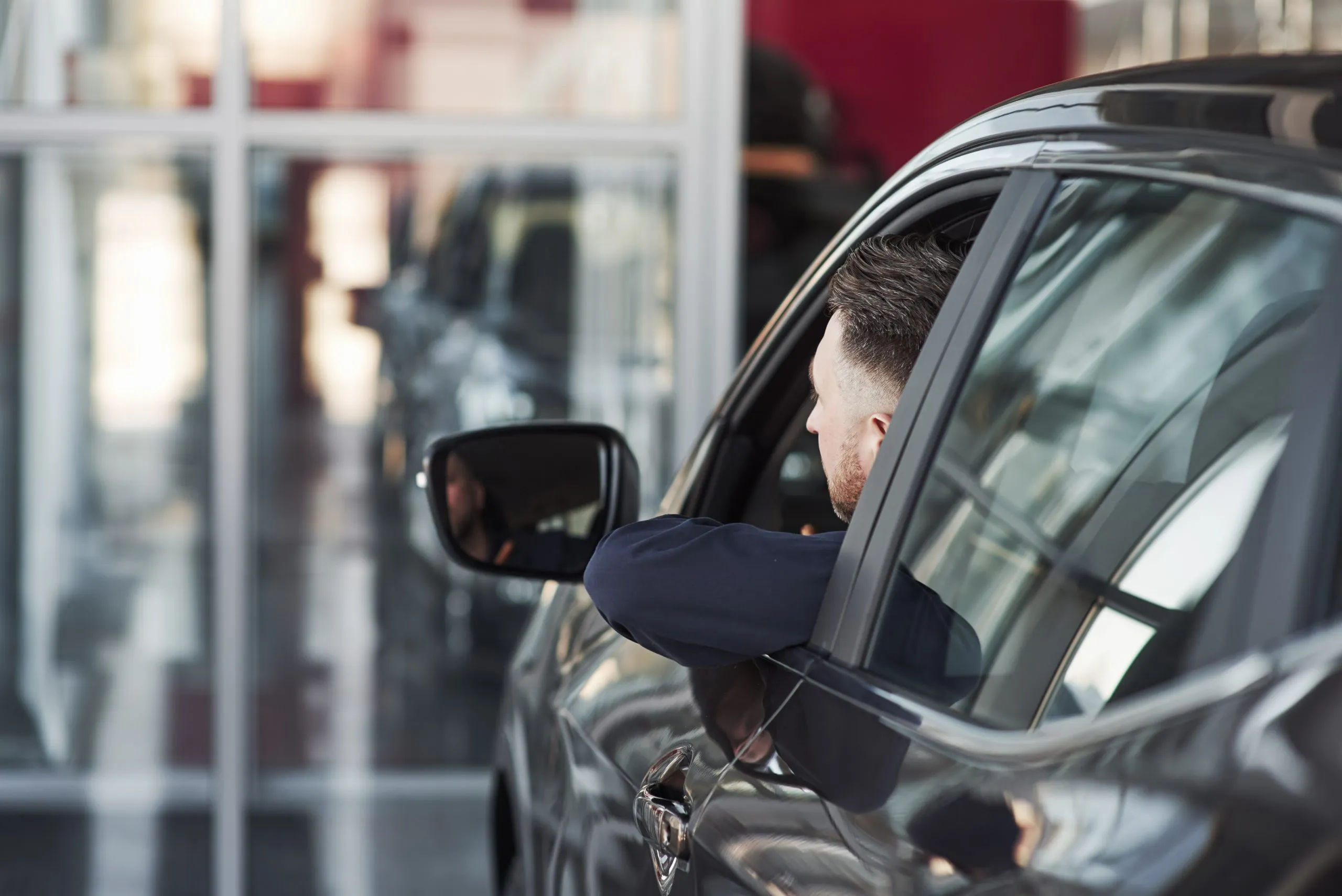 The future of Side Windows in the USA shaped by market insights, innovations, and a projected 4% CAGR growth man-official-clothes-trying-his-new-car-automobile-salon-scaled