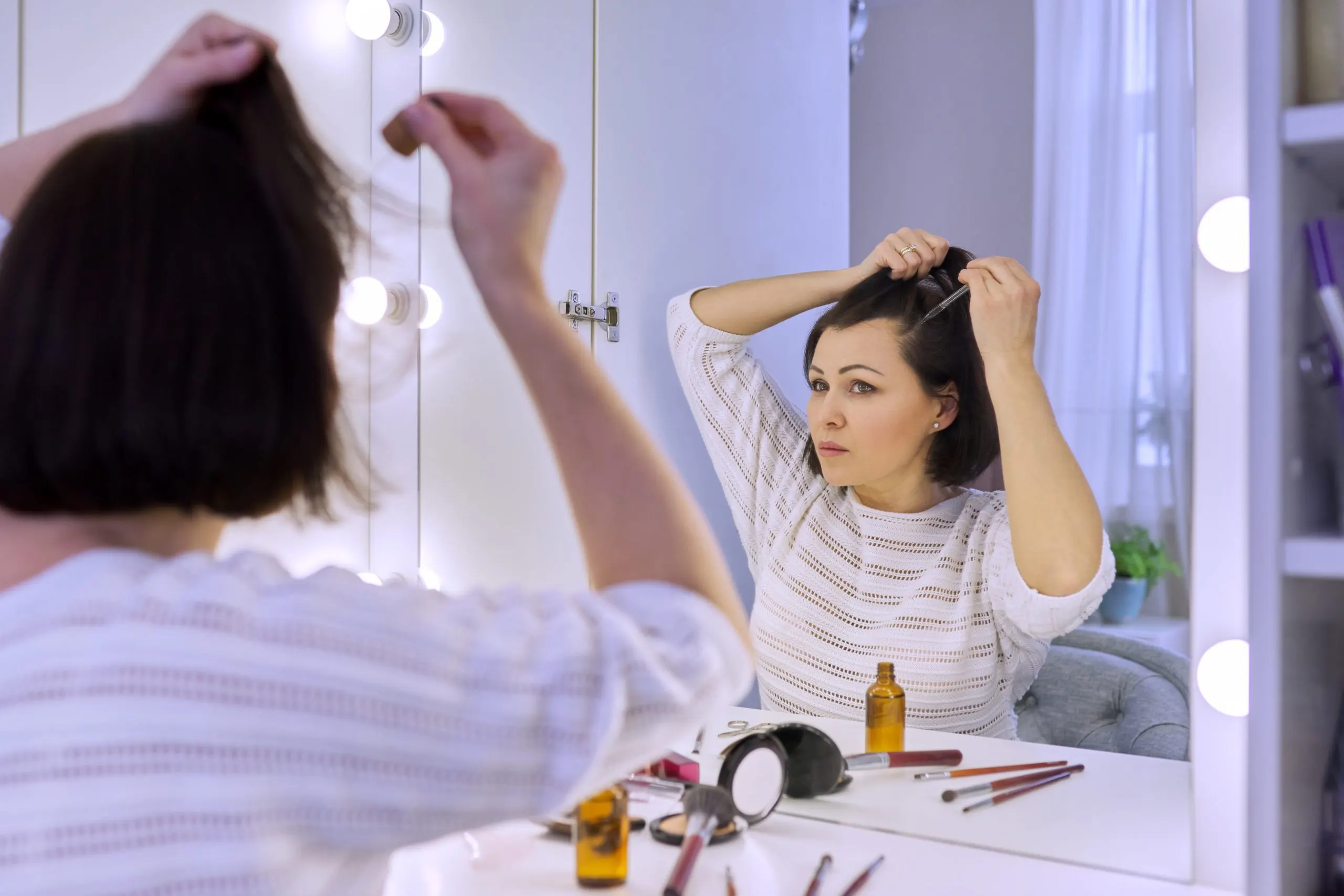 Singapore Hair Loss Treatment Products Market Outlook to 2035 mature-woman-treating-caring-hair-using-cosmetic-medical-products-bottle-with-pipette-middle-aged-female-sitting-home-looking-mirror-hair-loss-problem-special-professional-preparations-scaled