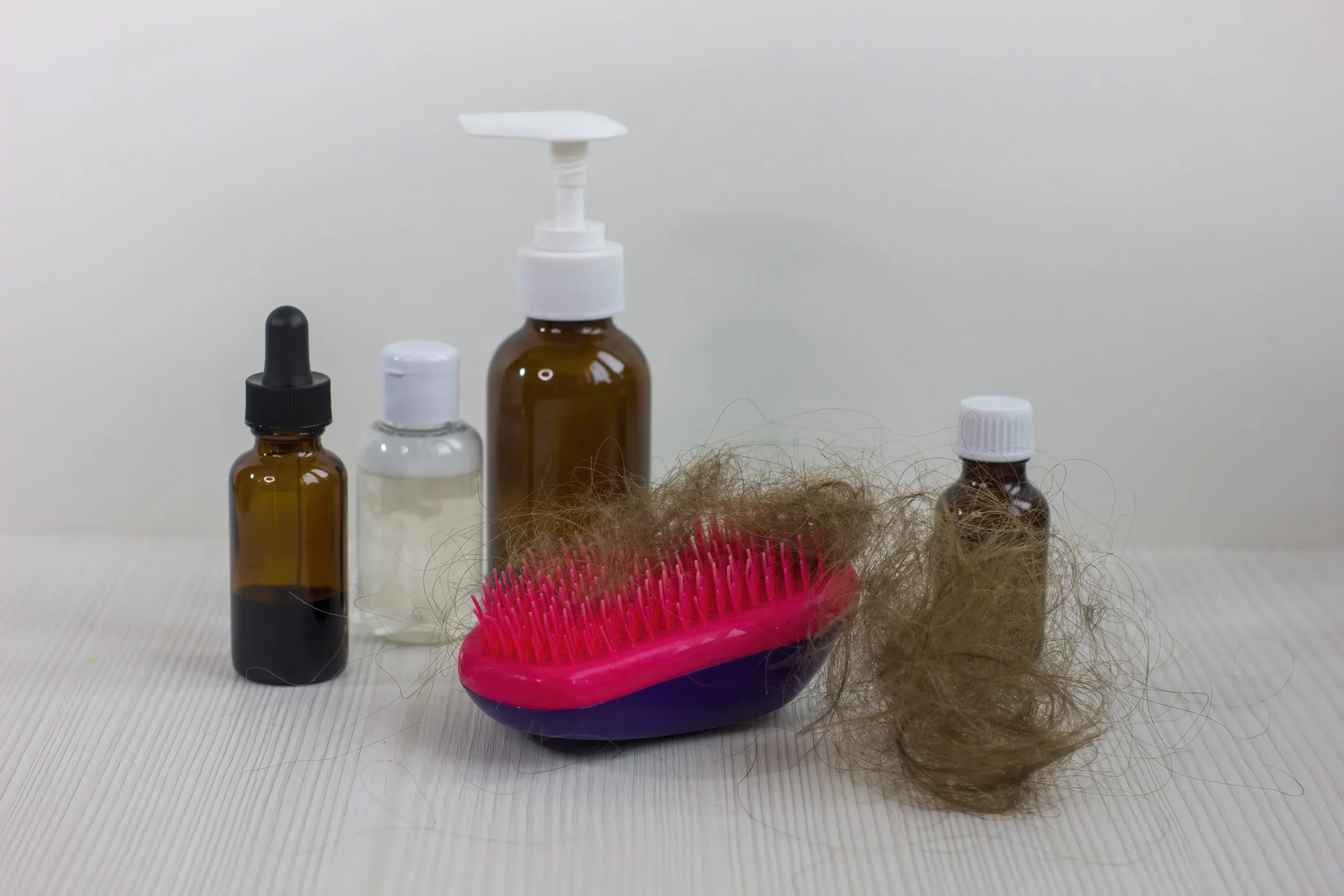 USA Hair Loss Treatment Products Market Outlook to 2035 medication-bottles-hairbrush-white-wooden-table-hair-loss-problem-1-scaled