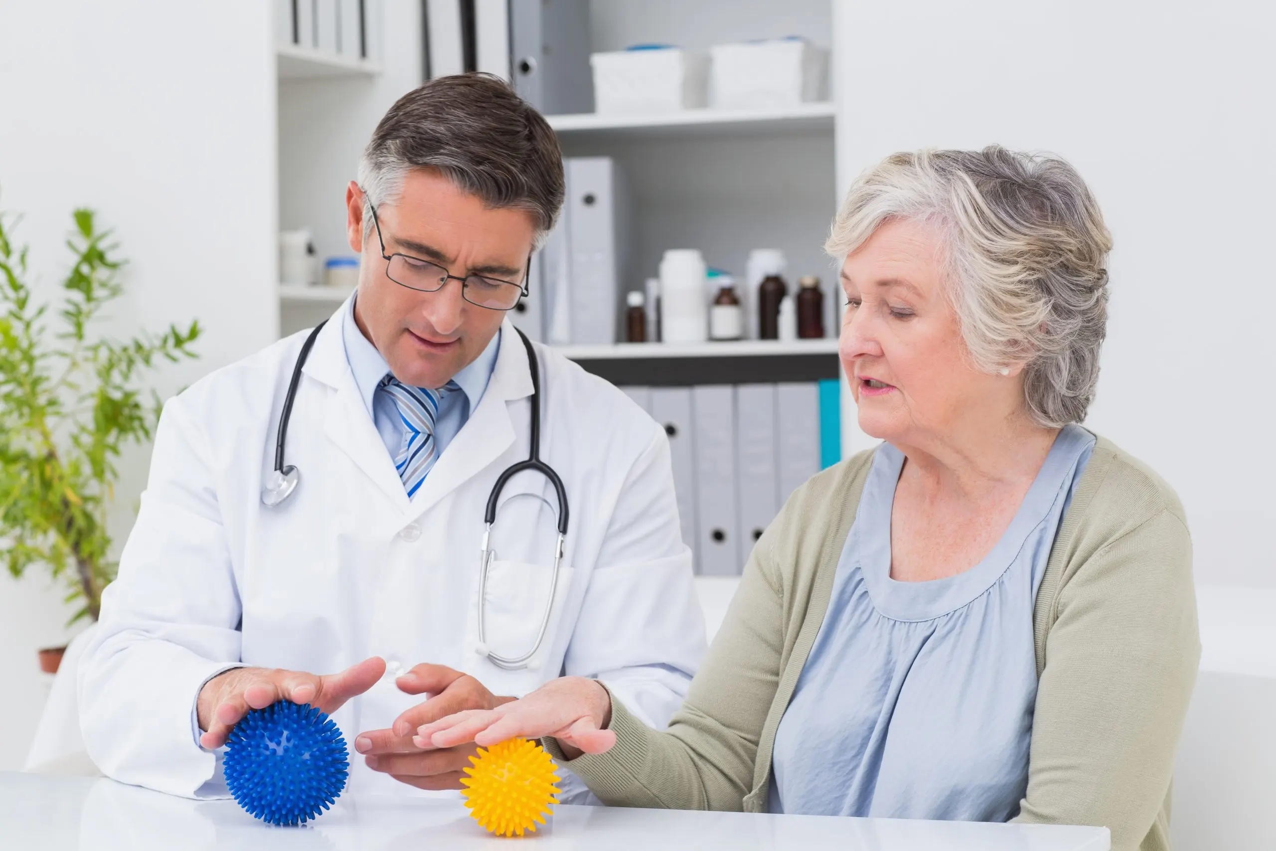 UAE Cognitive Rehabilitation Market Outlook 2035 physiotherapist-guiding-female-patient-with-massage-ball-scaled
