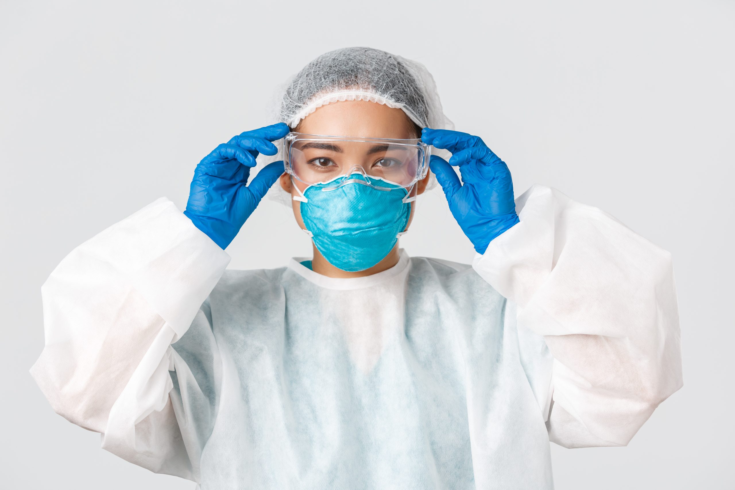 portrait-woman-wearing-mask-against-white-background-scaled