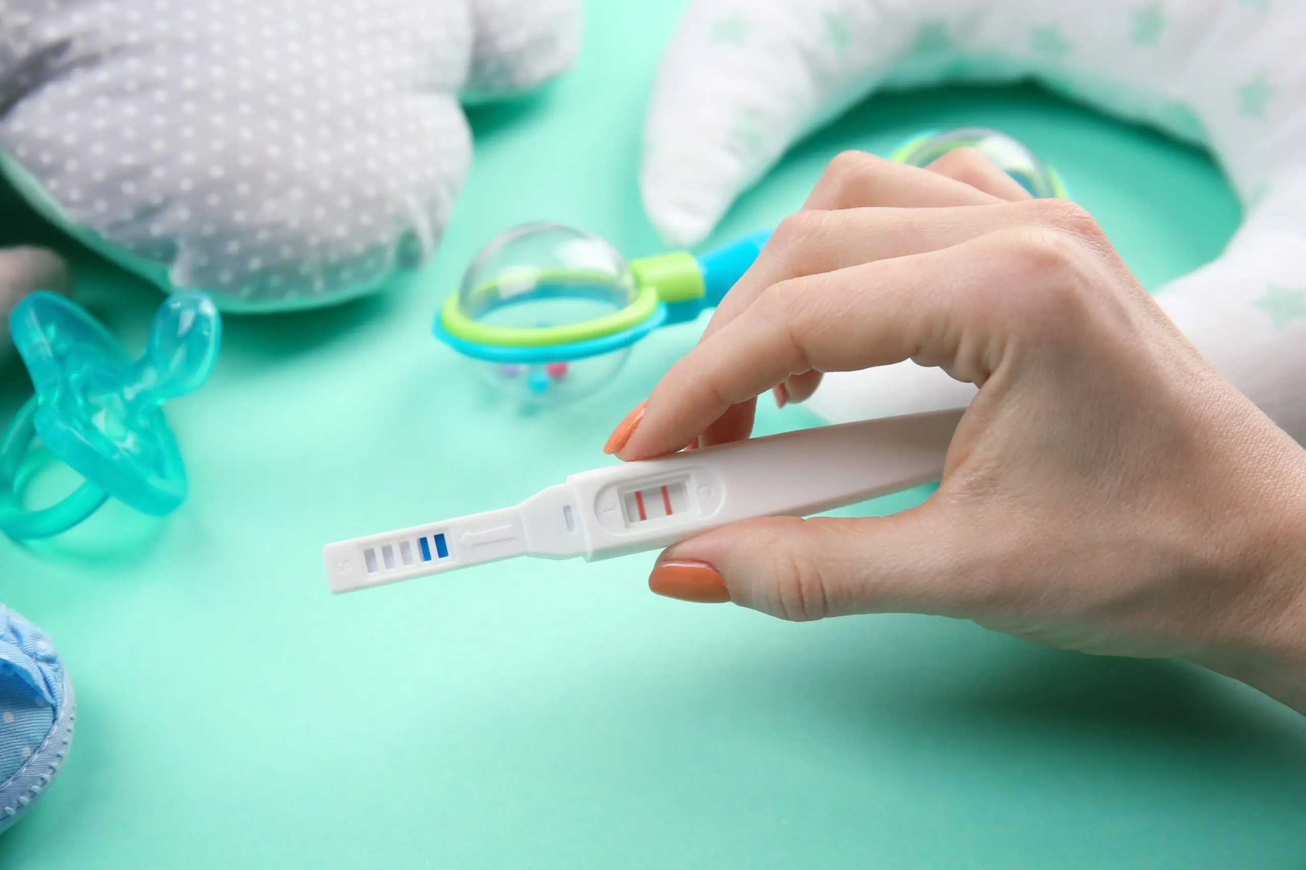 KSA Early Detection Pregnancy Tests Market Outlook 2035 pregnancy-test-hand-baby-accessories-turquoise-background-1-scaled