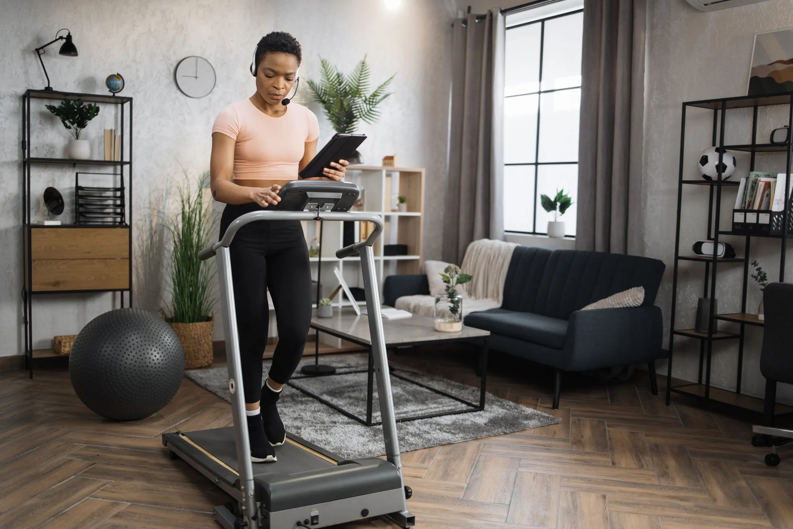 USA Home Fitness Equipment Market Outlook to 2035 side-view-african-woman-sport-clothes-using-headset-working-tablet-computer-scaled