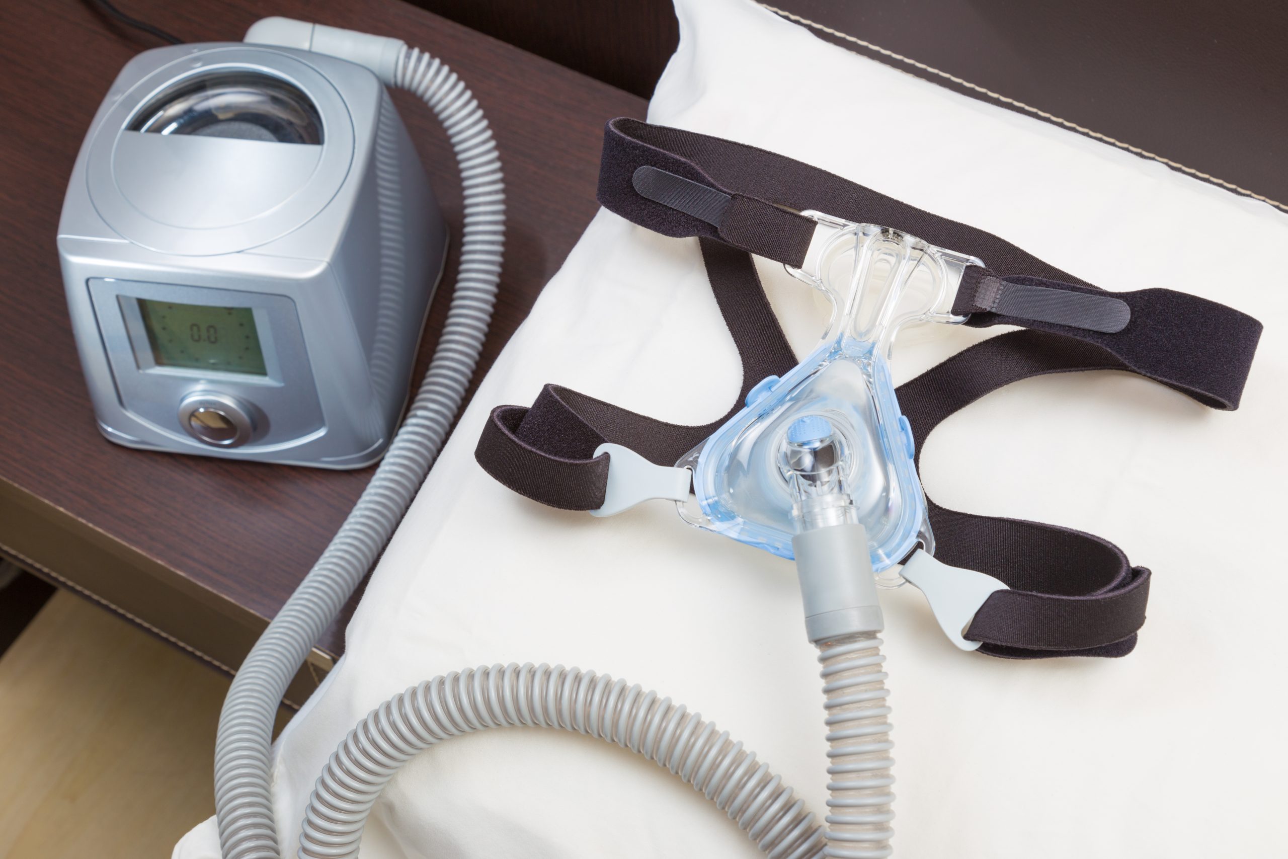 sleep-apnea-cpap-machine-with-headgear-hose-scaled
