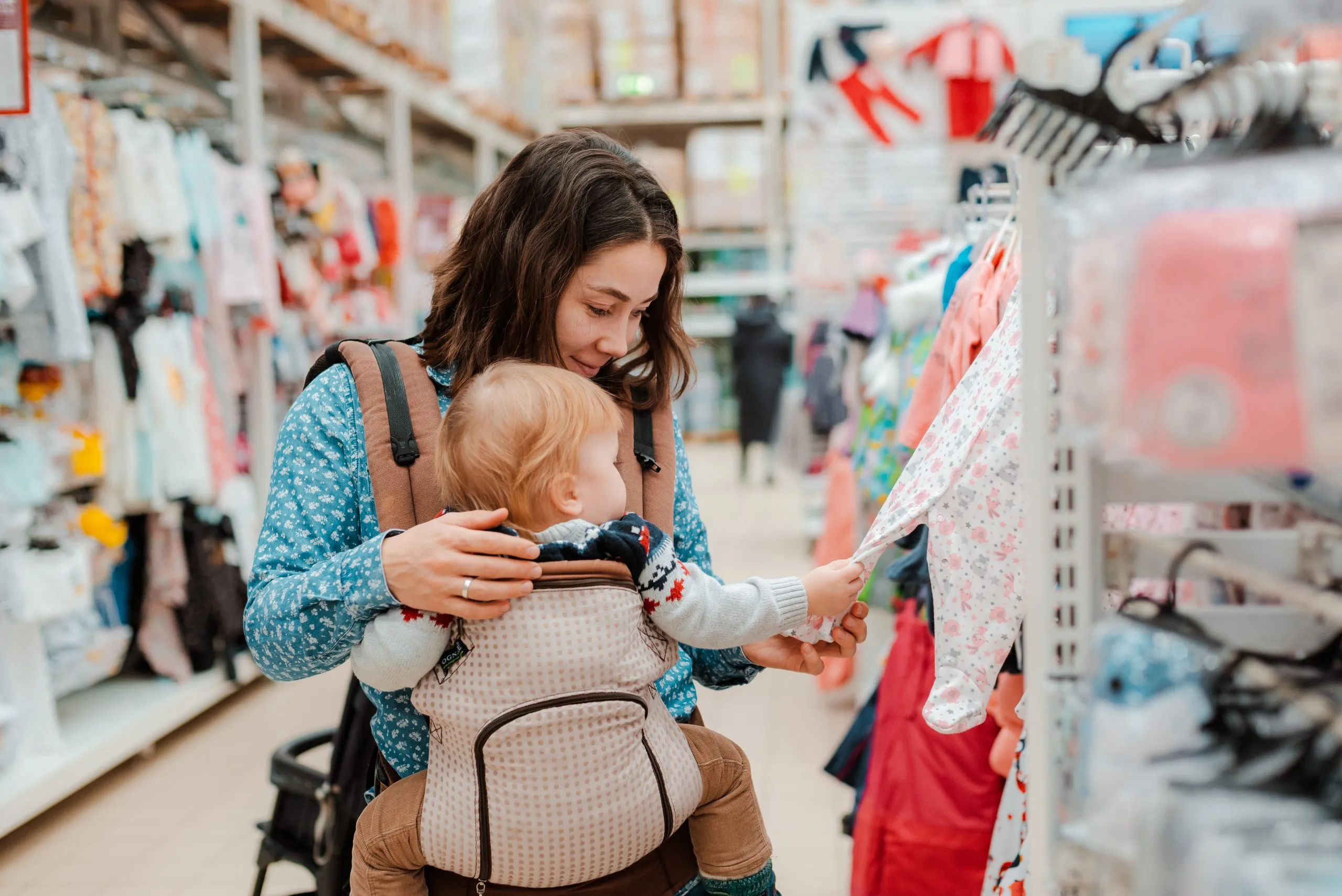 India Baby Products Market Outlook 2035 young-mother-with-baby-son-shopping-supermarket-scaled