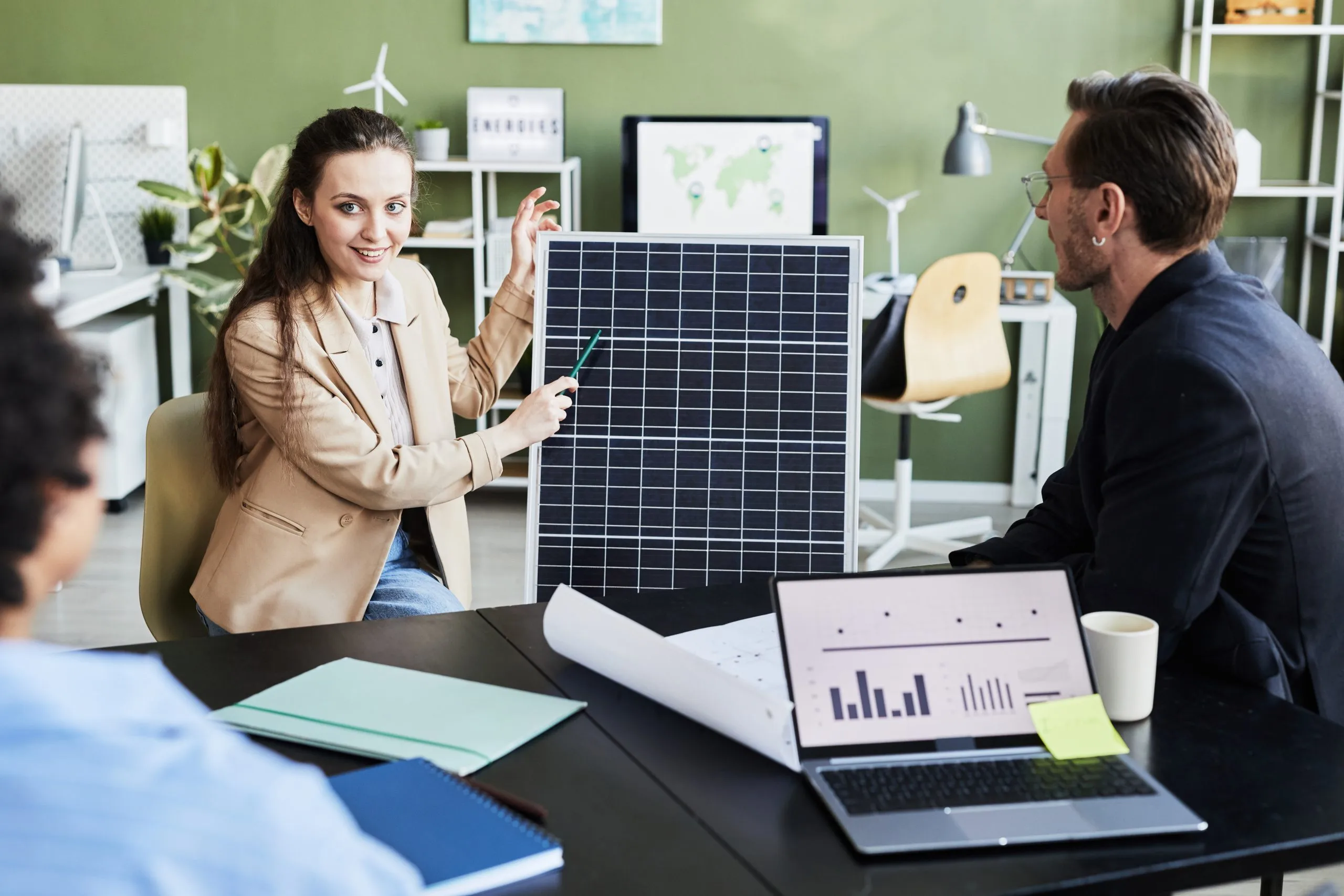 Oman Solar PV Market to See Rising Demand for Sustainable Energy Solutions with 10% Growth by 2035 young-woman-presenting-solar-panel-her-colleagues-business-meeting-office-scaled