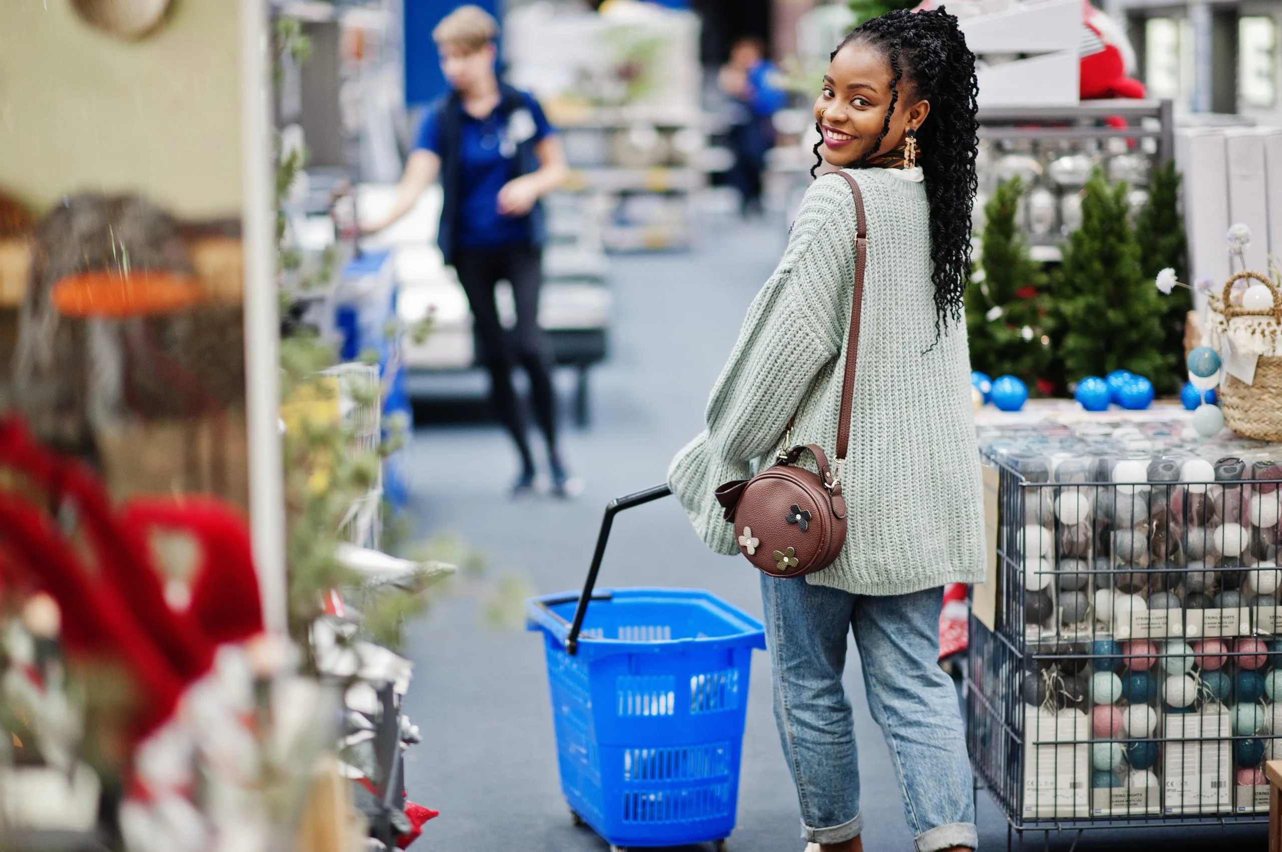 Nigeria Adult Diaper Market Outlook to 2035 african-woman-walking-with-shopping-basket-modern-home-furnishings-store-1-scaled