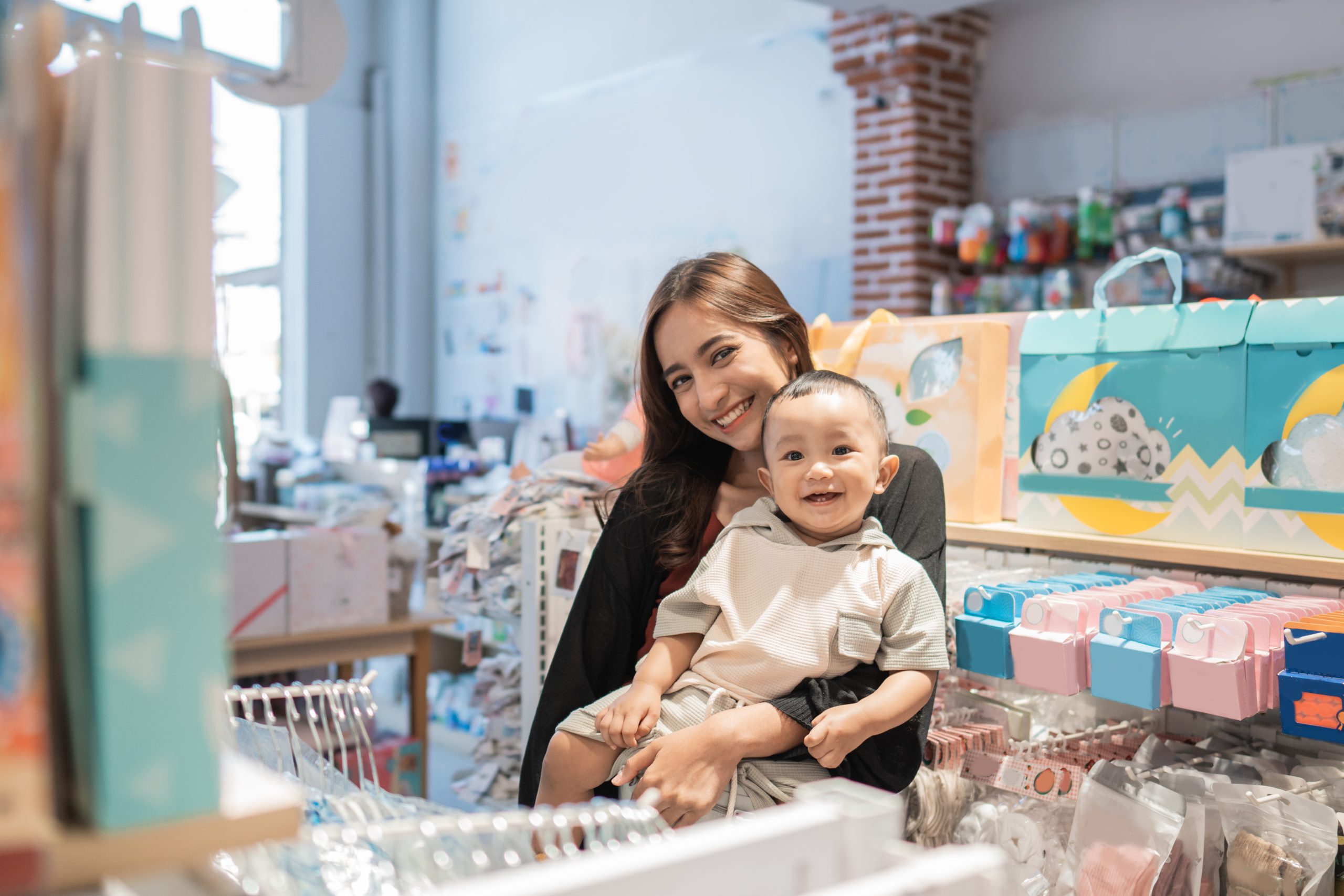 Singapore Baby Diapers Market Outlook to 2035 asian-mother-with-her-toddler-boy-shopping-baby-shop-1-scaled