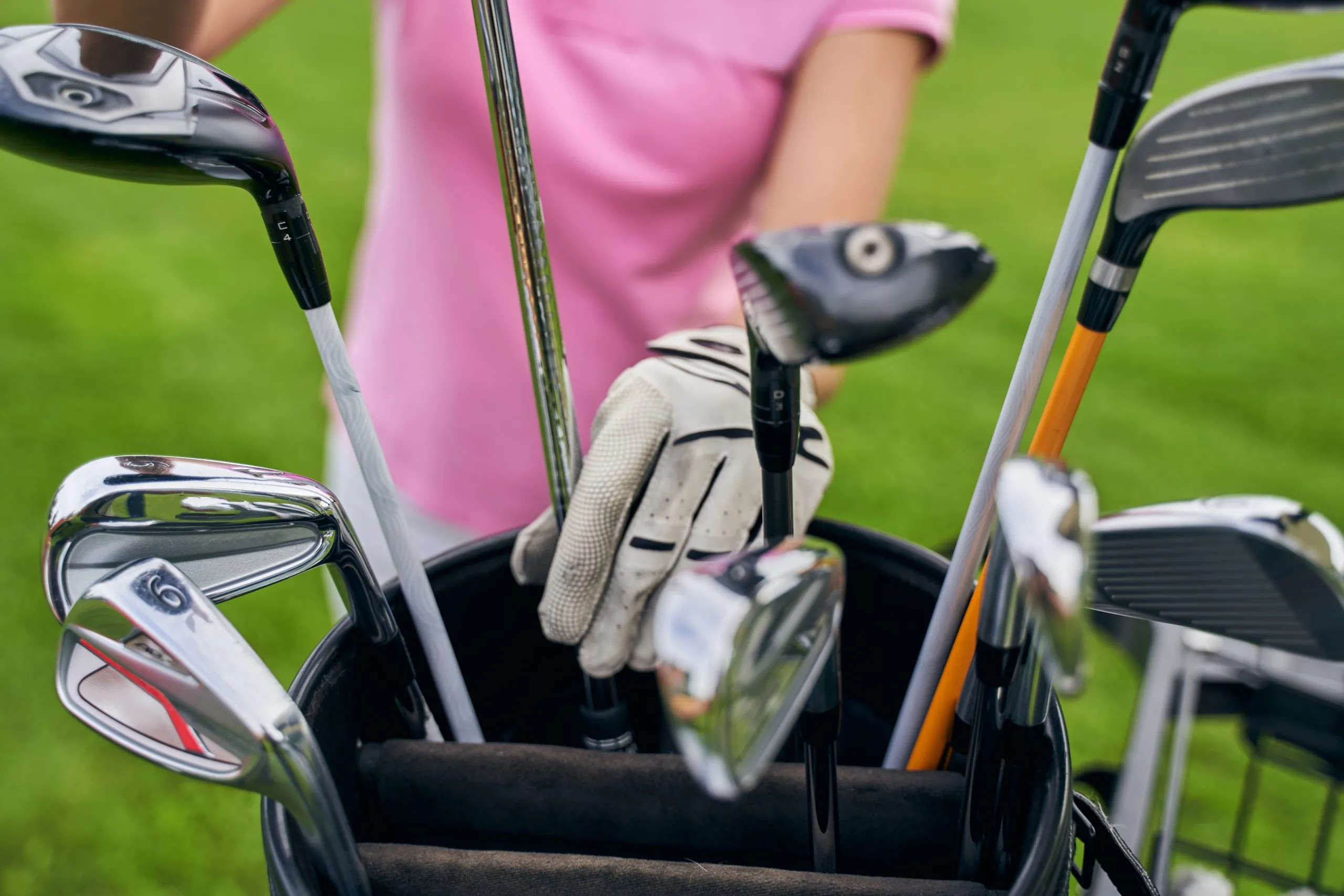 UAE Golf Equipment Market Outlook to 2035 caucasian-sportswoman-reaching-iron-club-leather-bag-scaled