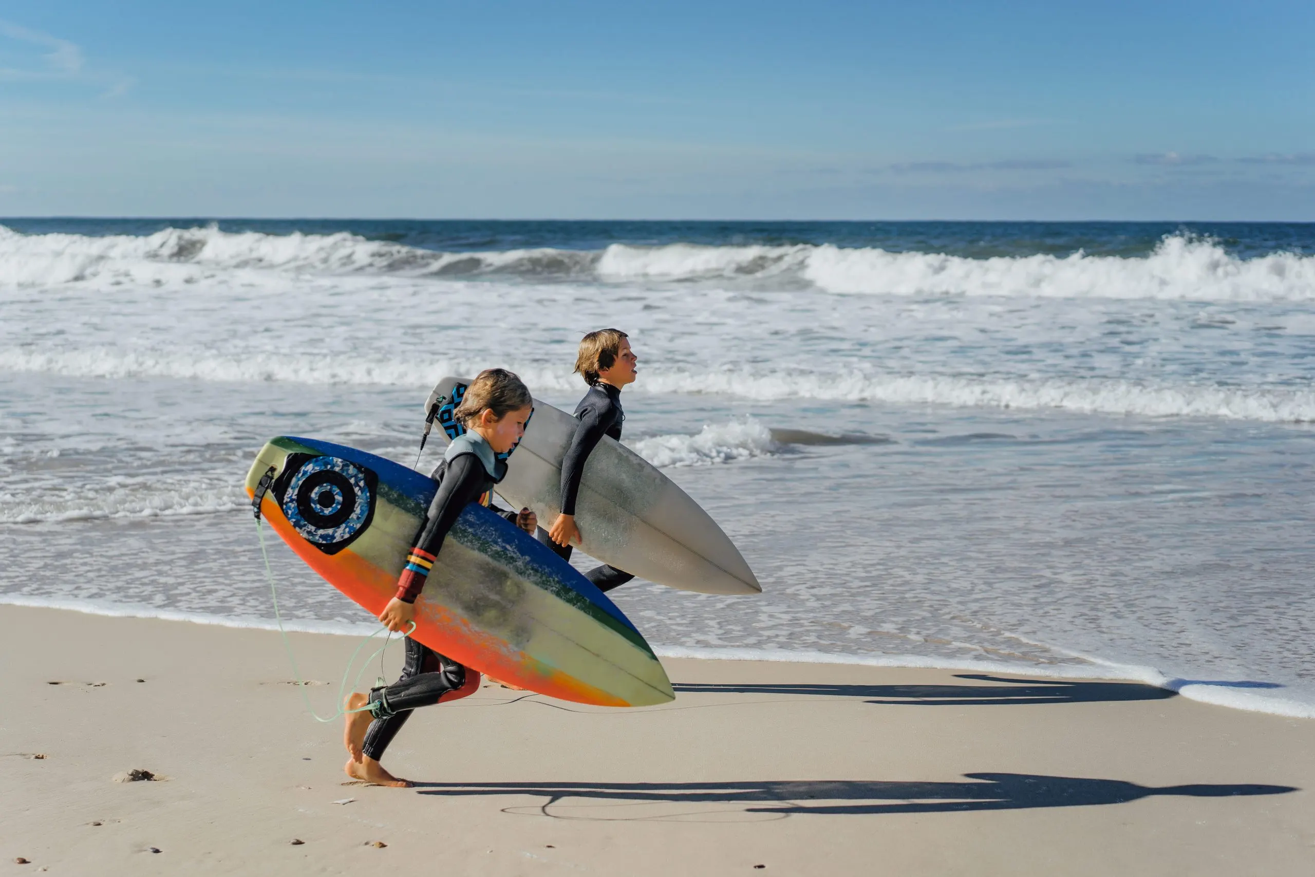 UK Surfing Equipment Market Outlook to 2035 children-surfing-nazare-portugal-children-teenagers-wetsuits-surf-boards-1-scaled