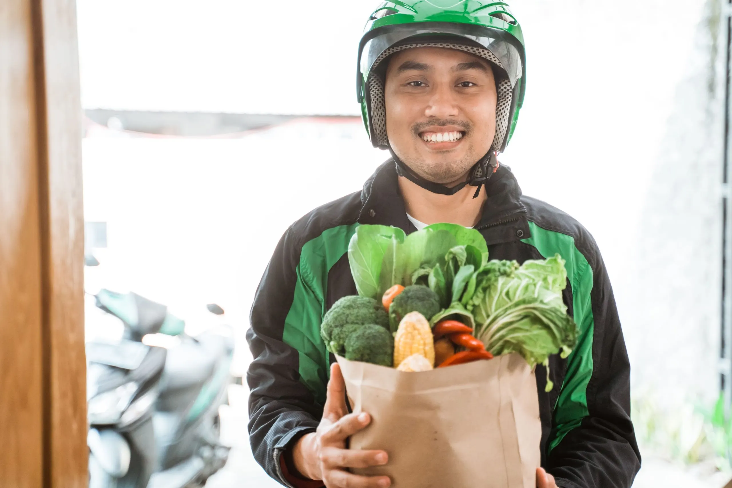 Nigeria Online Grocery Delivery Market Outlook to 2035 delivery-man-delivering-grocery-1-scaled