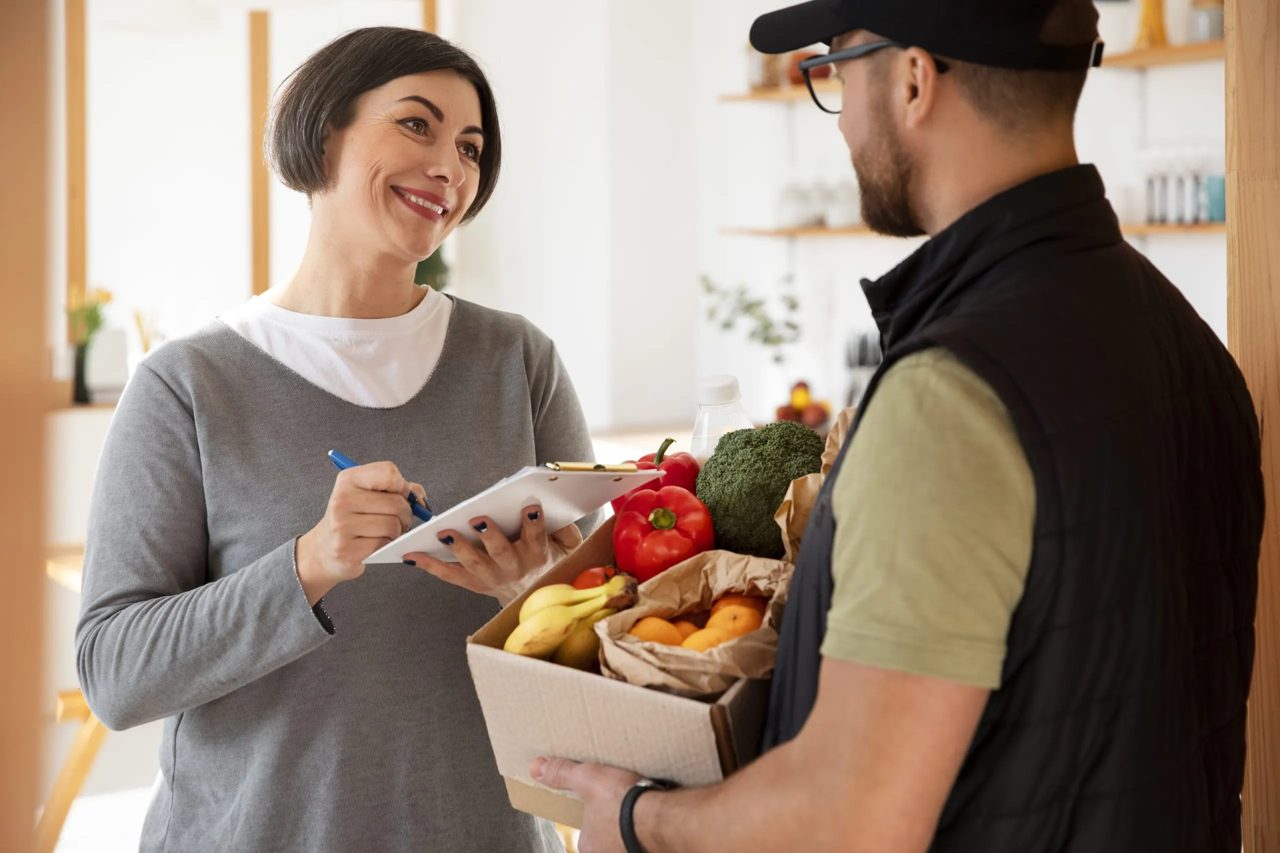 Vietnam Online Grocery Delivery Market Outlook to 2035 delivery-man-giving-groceries-order-customer-scaled