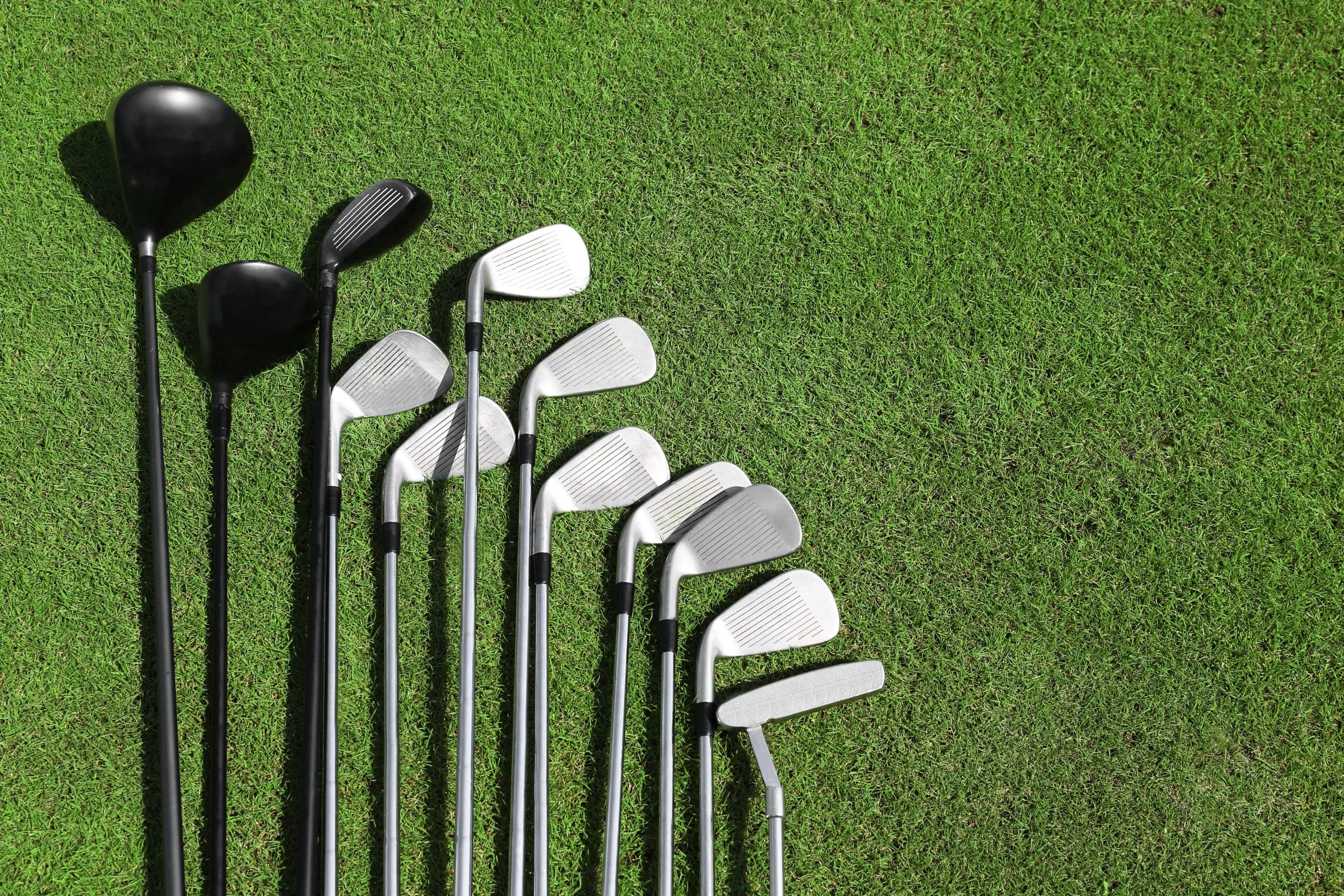 South Africa Golf Equipment Market Outlook to 2035 different-golf-clubs-row-green-grass-scaled
