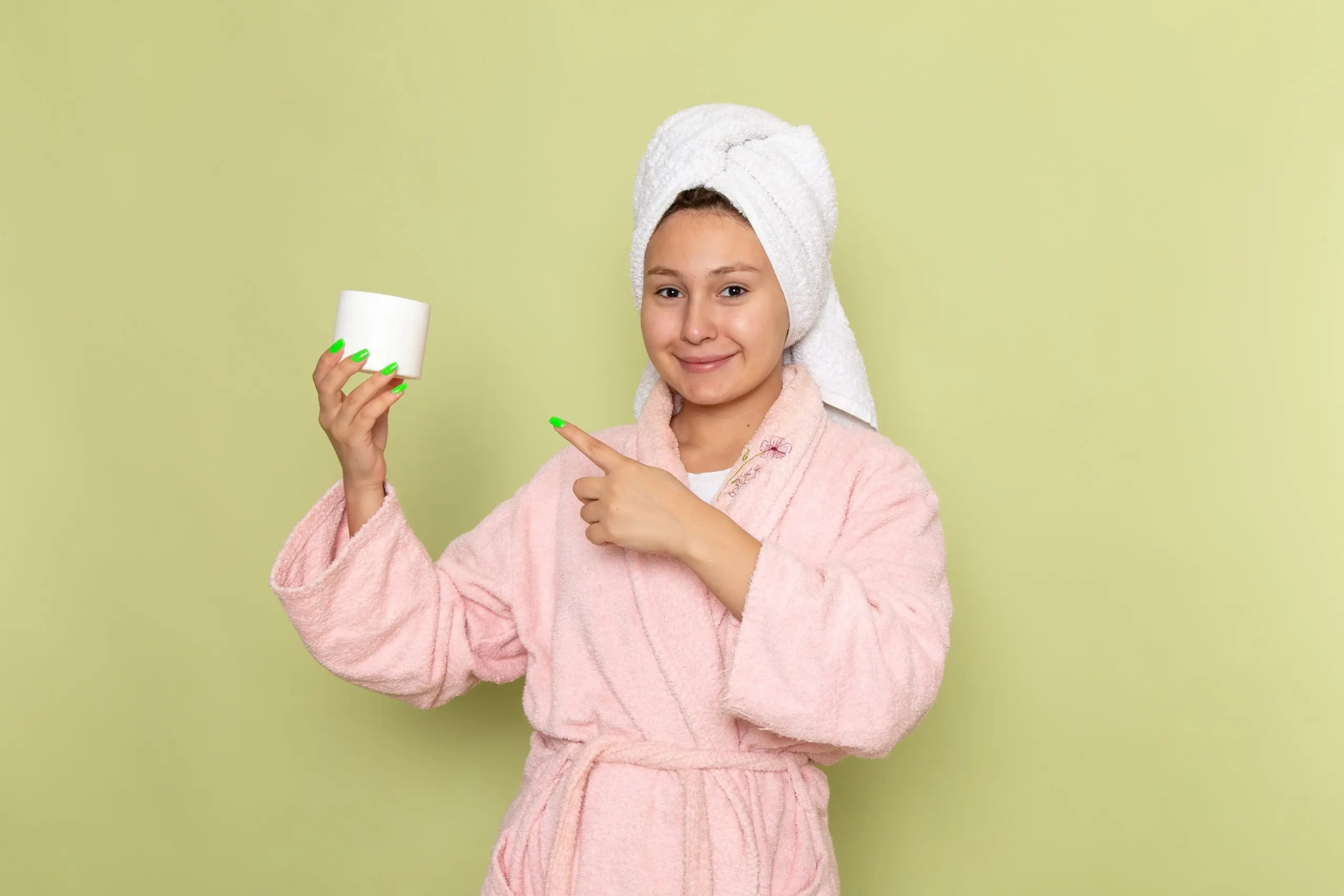 KSA Feminine Wipes Market Outlook to 2035 female-pink-bathrobe-smiling-holding-cream-scaled