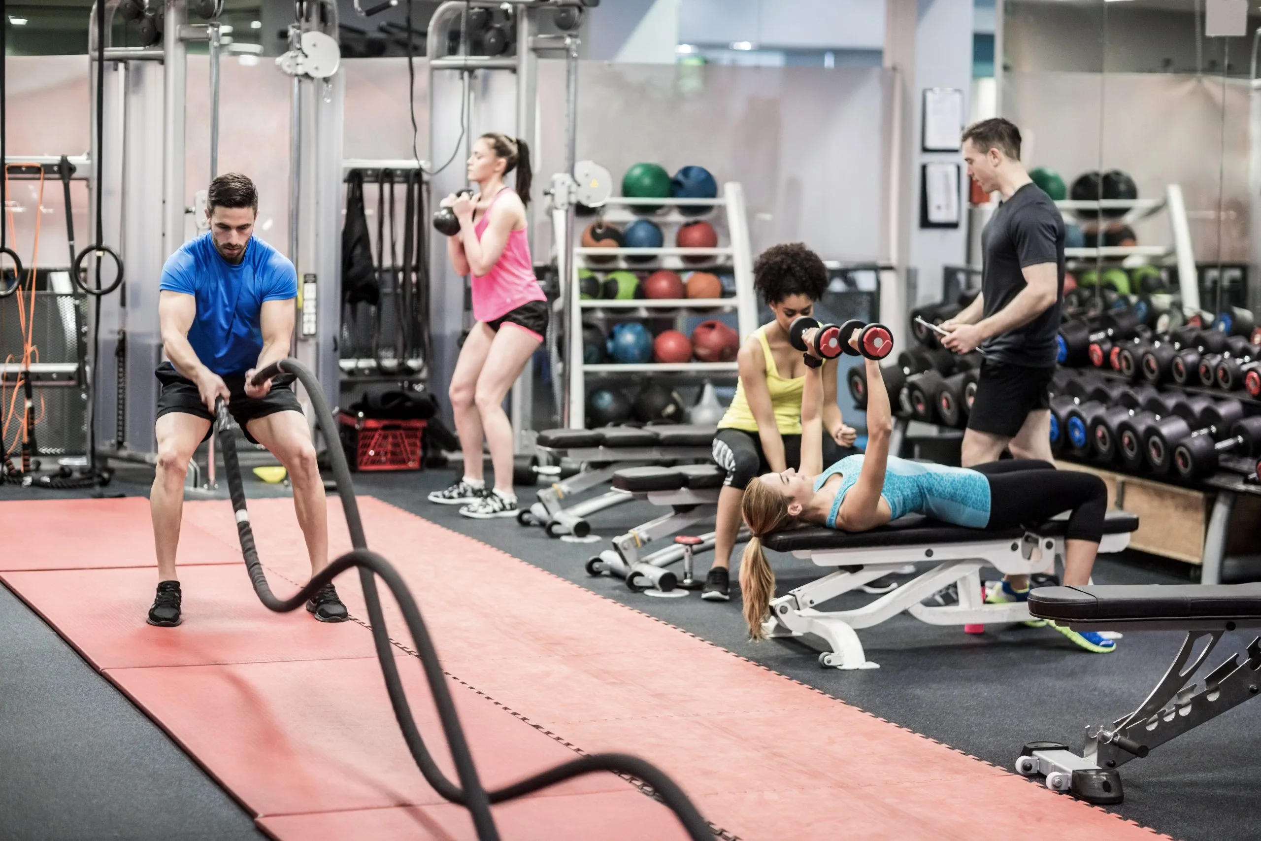 Singapore Health and Fitness Club Market Outlook to 2035 fit-people-working-out-weights-room-scaled