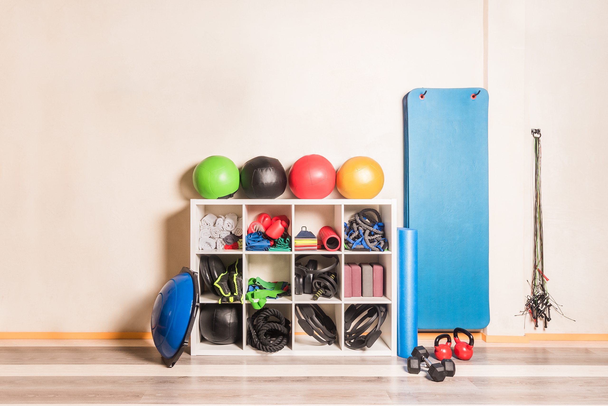 front-view-gym-equipment-arranged-shelves-wall-concept-gym-equipment-scaled