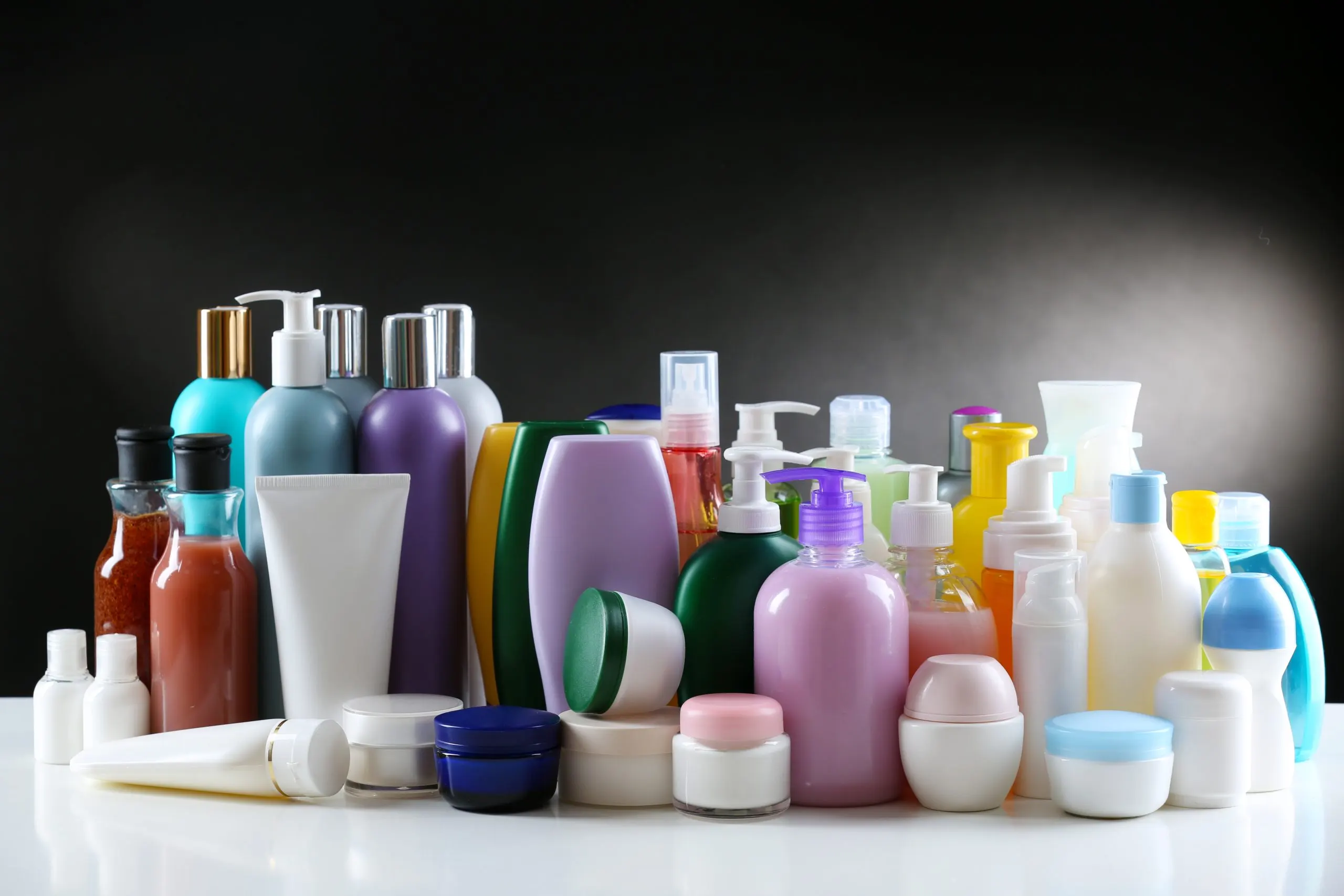 UK Face Wash Market Outlook to 2035 group-cosmetic-bottles-dark-background-scaled