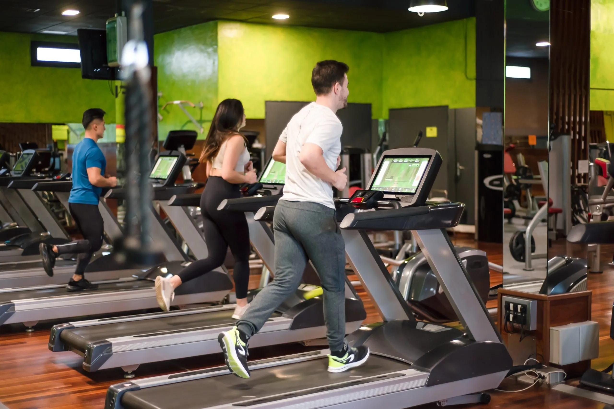 KSA Health and Fitness Club Market Outlook to 2035 group-people-running-treadmills-modern-sport-gym-scaled