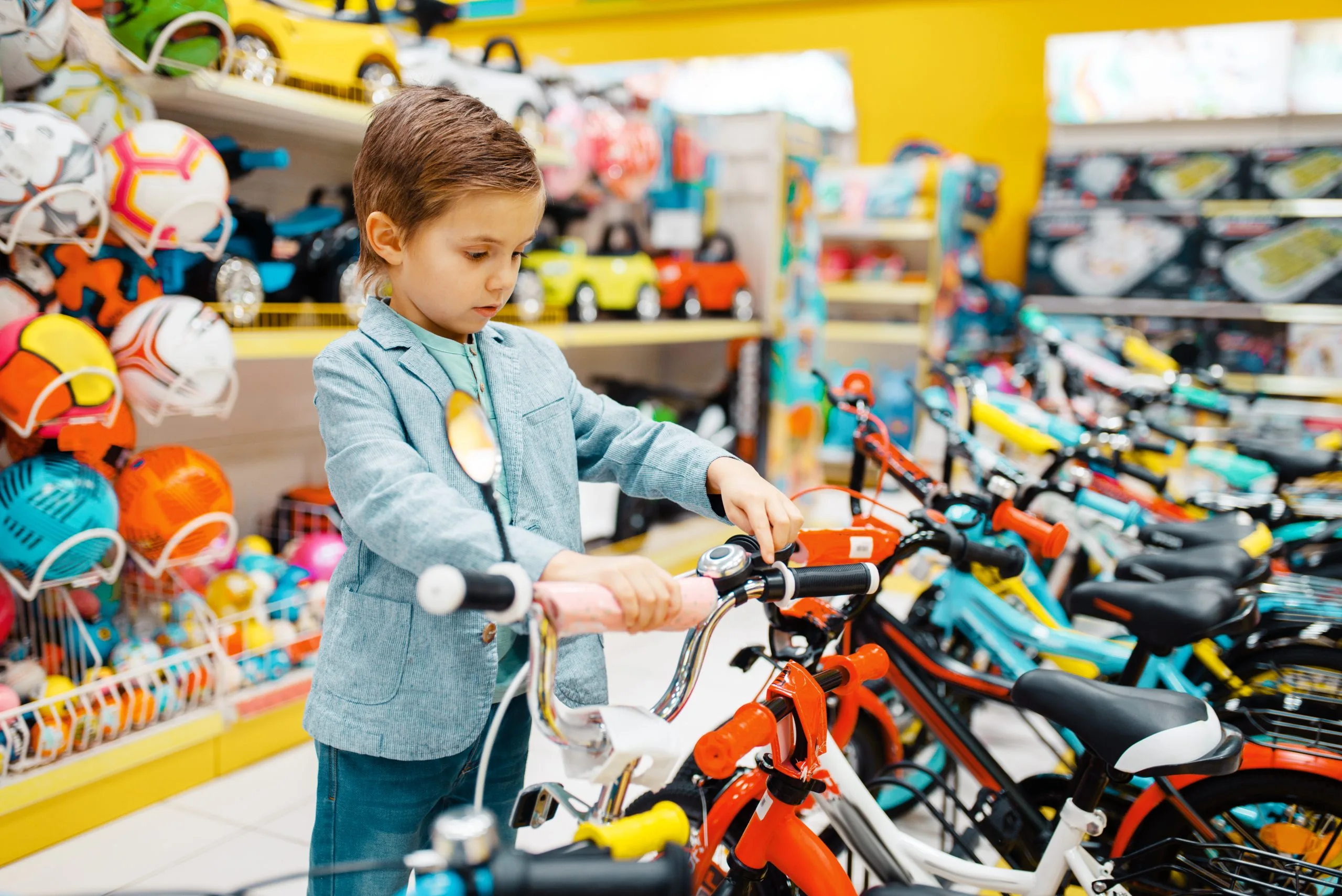 Brazil Bicycle Market Outlook to 2035 little-boy-buying-bicycle-kids-store-scaled