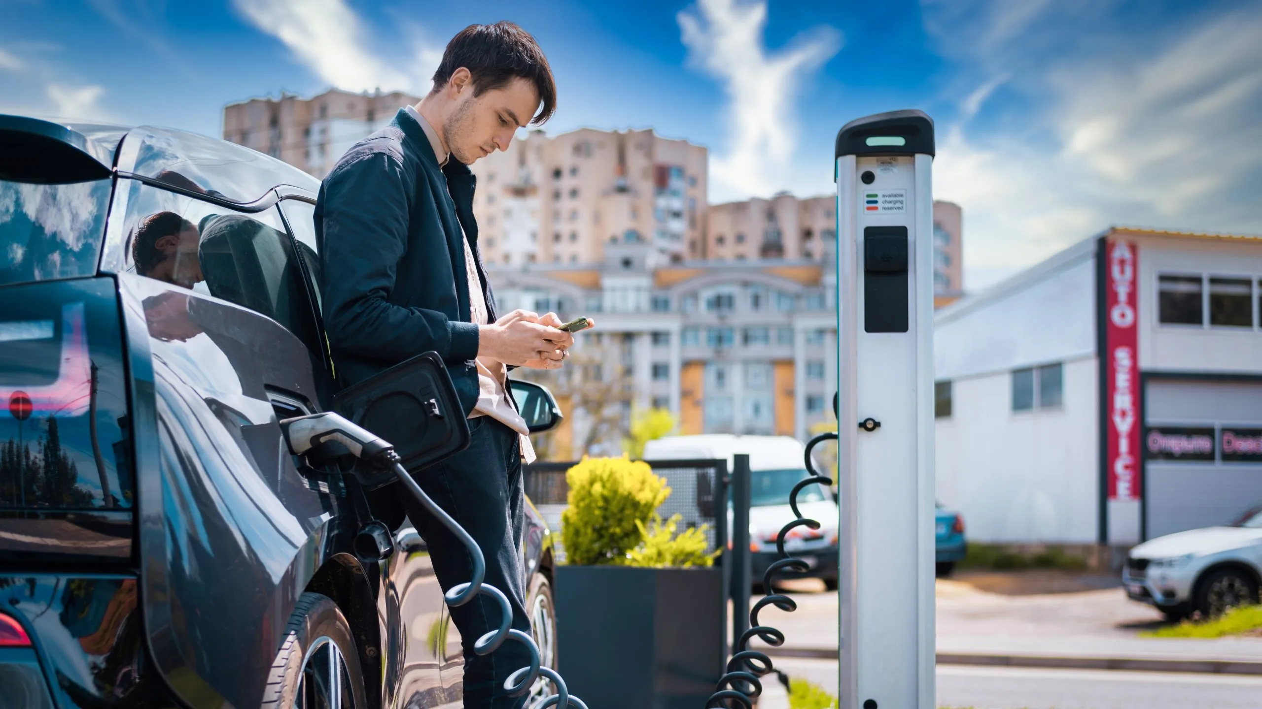 Powering the Future of the Philippines EV Charging Infrastructure Market with Forecast Growth at 27 % CAGR value man-charging-his-electric-car-charge-station-using-smartphone-scaled