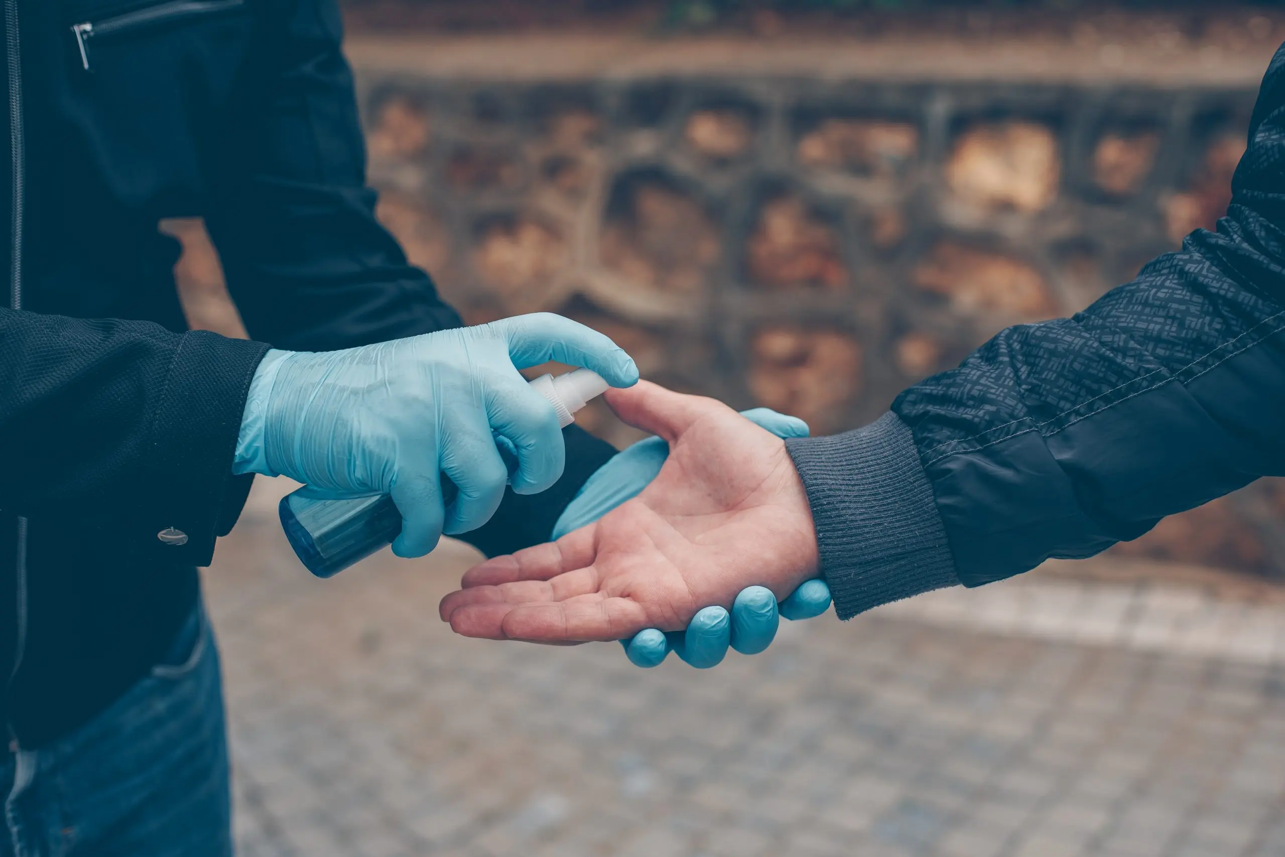 South Africa Hand Gloves Market Showing $450M Revenue and 8% CAGR Growth, Trends, and Key Drivers man-sanitizing-other-one-s-hand-gloves-yard-daytime-scaled