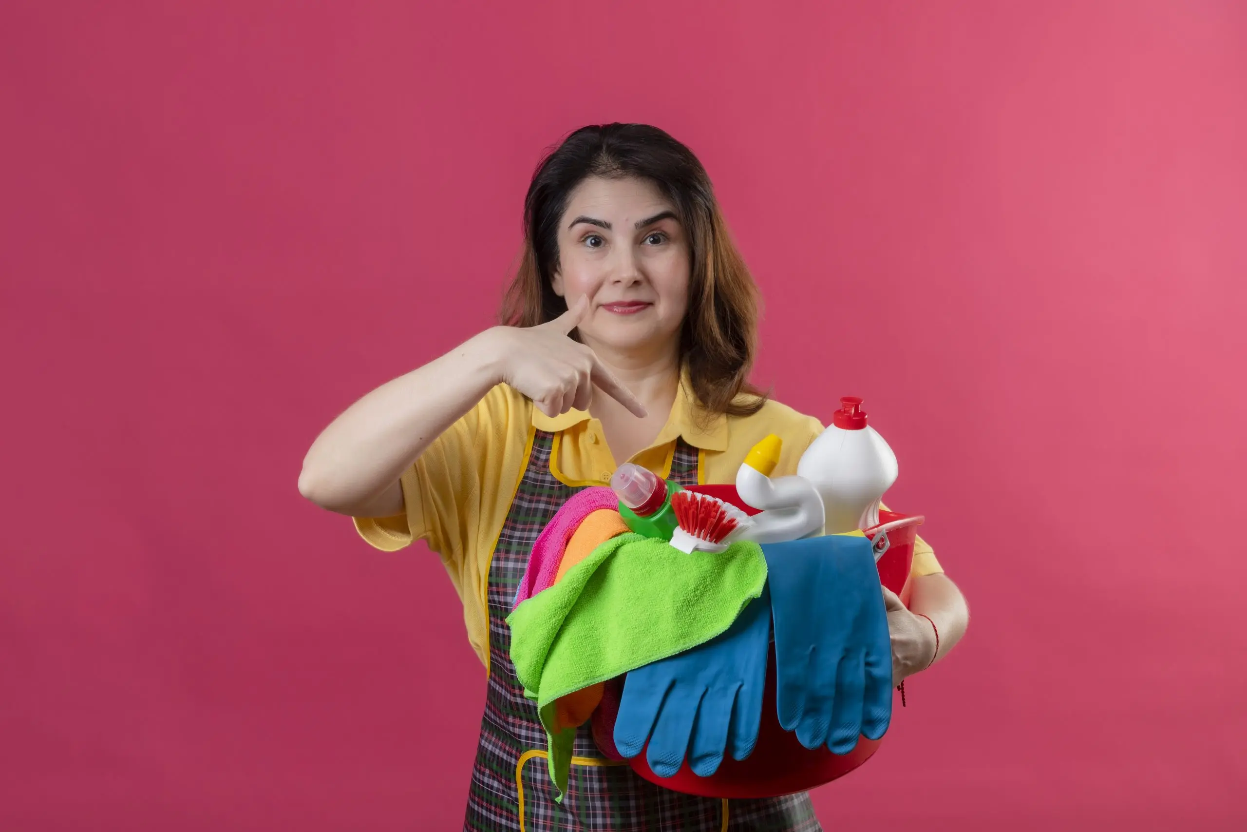 India Household Cleaners Market Outlook to 2035 middle-aged-woman-wearing-apron-holding-bucket-with-cleaning-tools-pointing-with-finger-it-smiling-standing-pink-wall-3-scaled