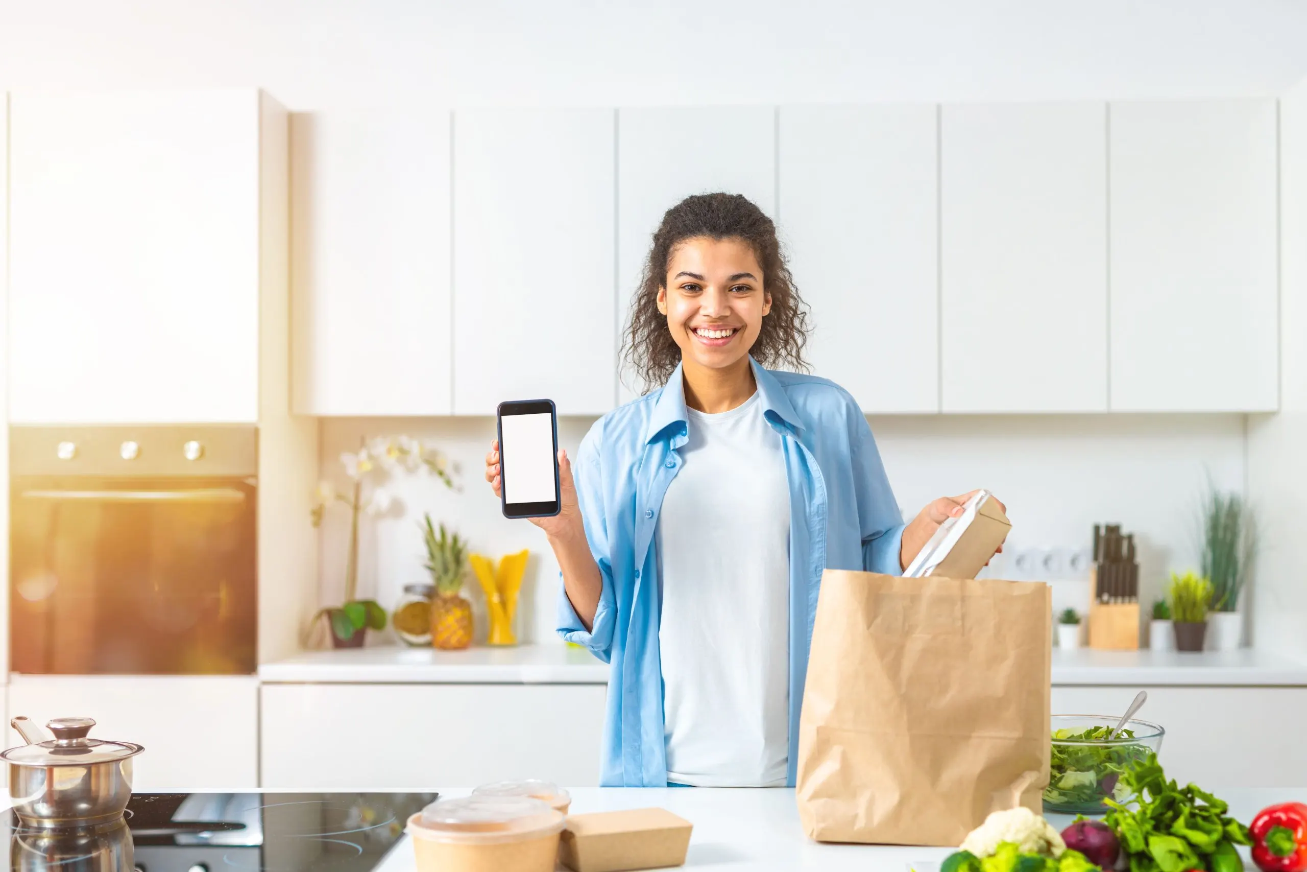 USA Online Grocery Delivery Market Outlook to 2035 smiling-woman-with-shopping-bag-ordered-online-via-smartphone-delivered-directly-home-1-scaled