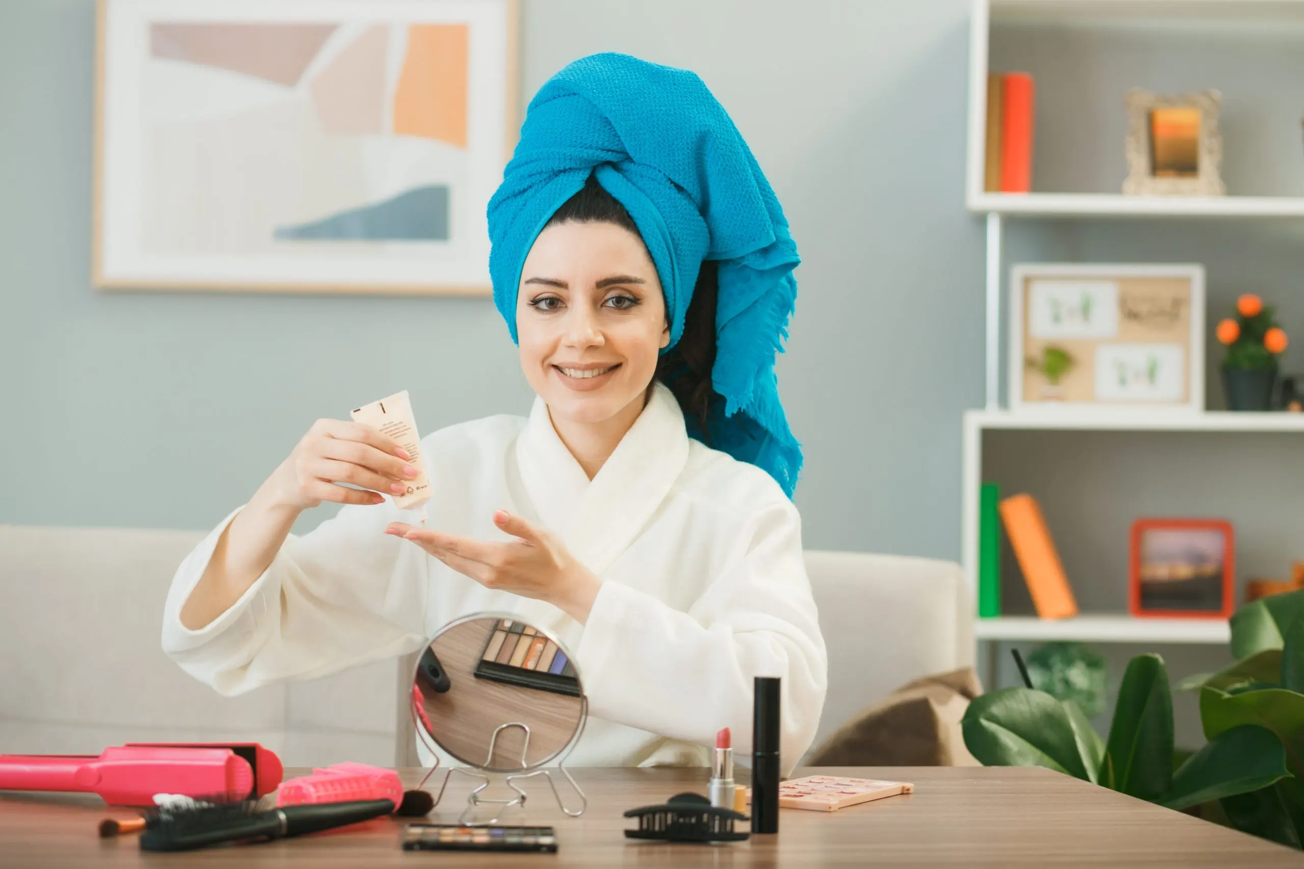 UAE Hair Care Market Outlook to 2035 smiling-young-girl-holding-tone-up-cream-wrapped-hair-towel-sitting-table-with-makeup-tools-living-room-scaled