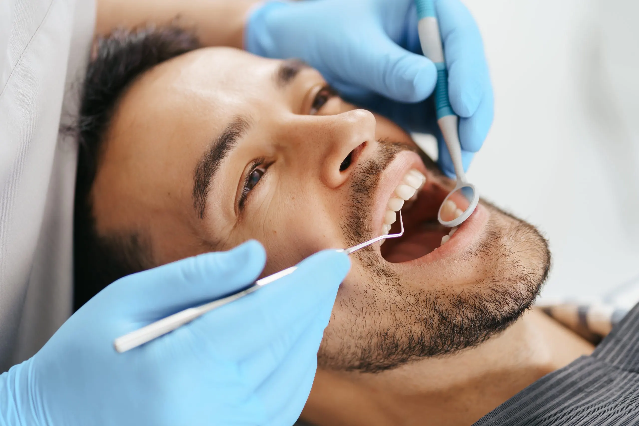KSA Oral Care Market Outlook to 2035 smiling-young-man-sitting-dentist-chair-while-doctor-examining-his-teeth-scaled