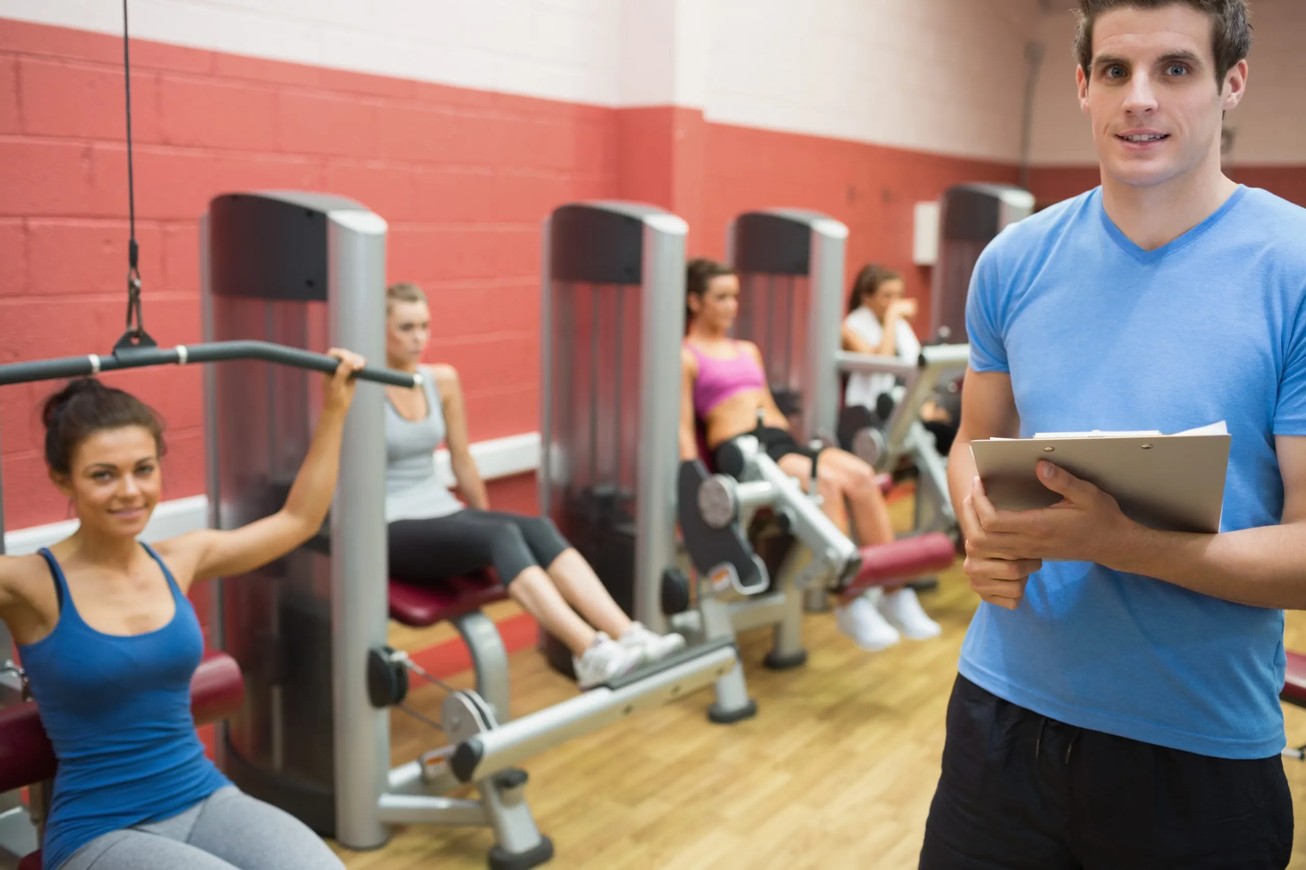 India Health and Fitness Club Market Outlook to 2035 trainer-weights-room-with-women-scaled