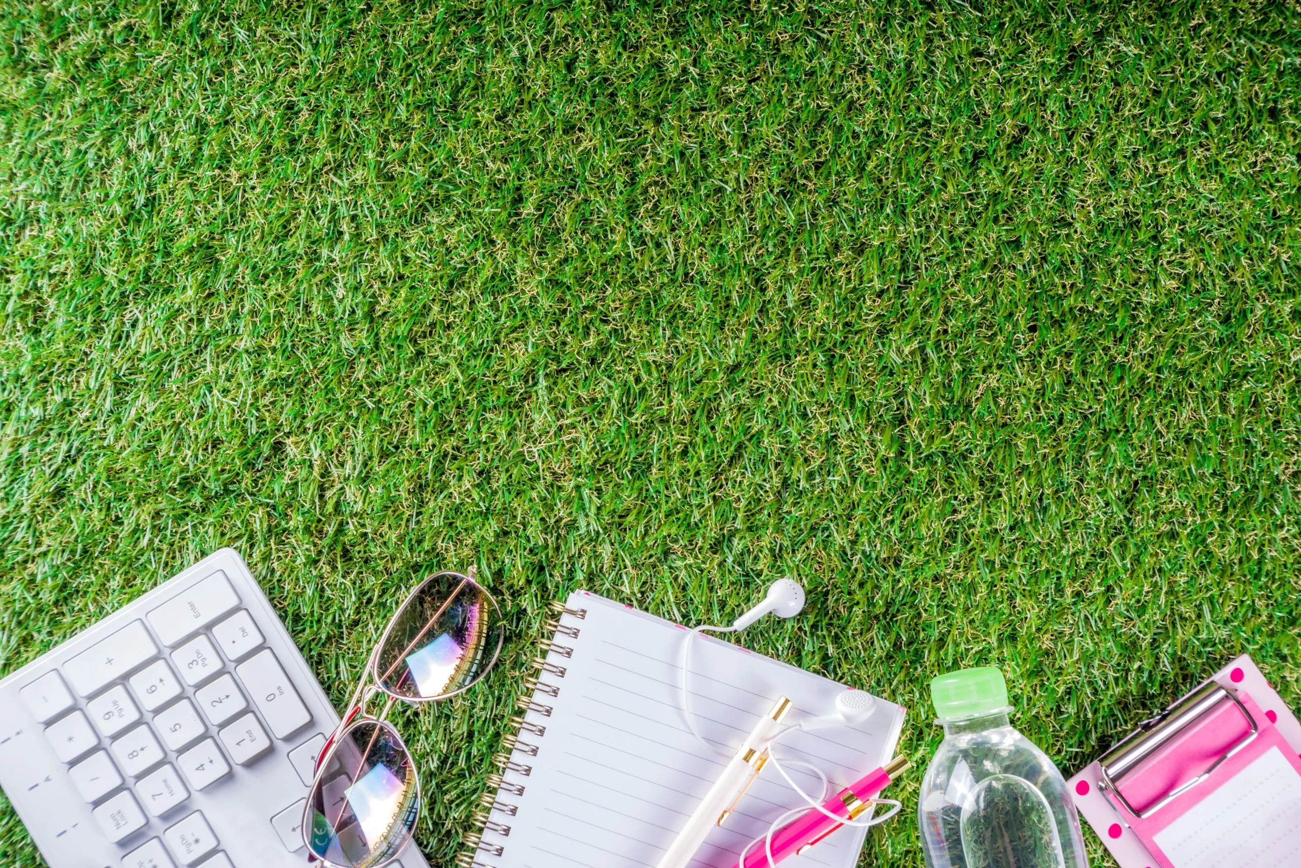 Singapore Artificial Turf Market Outlook to 2035 water-bottle-keyboard-notebook-green-grass-1-scaled