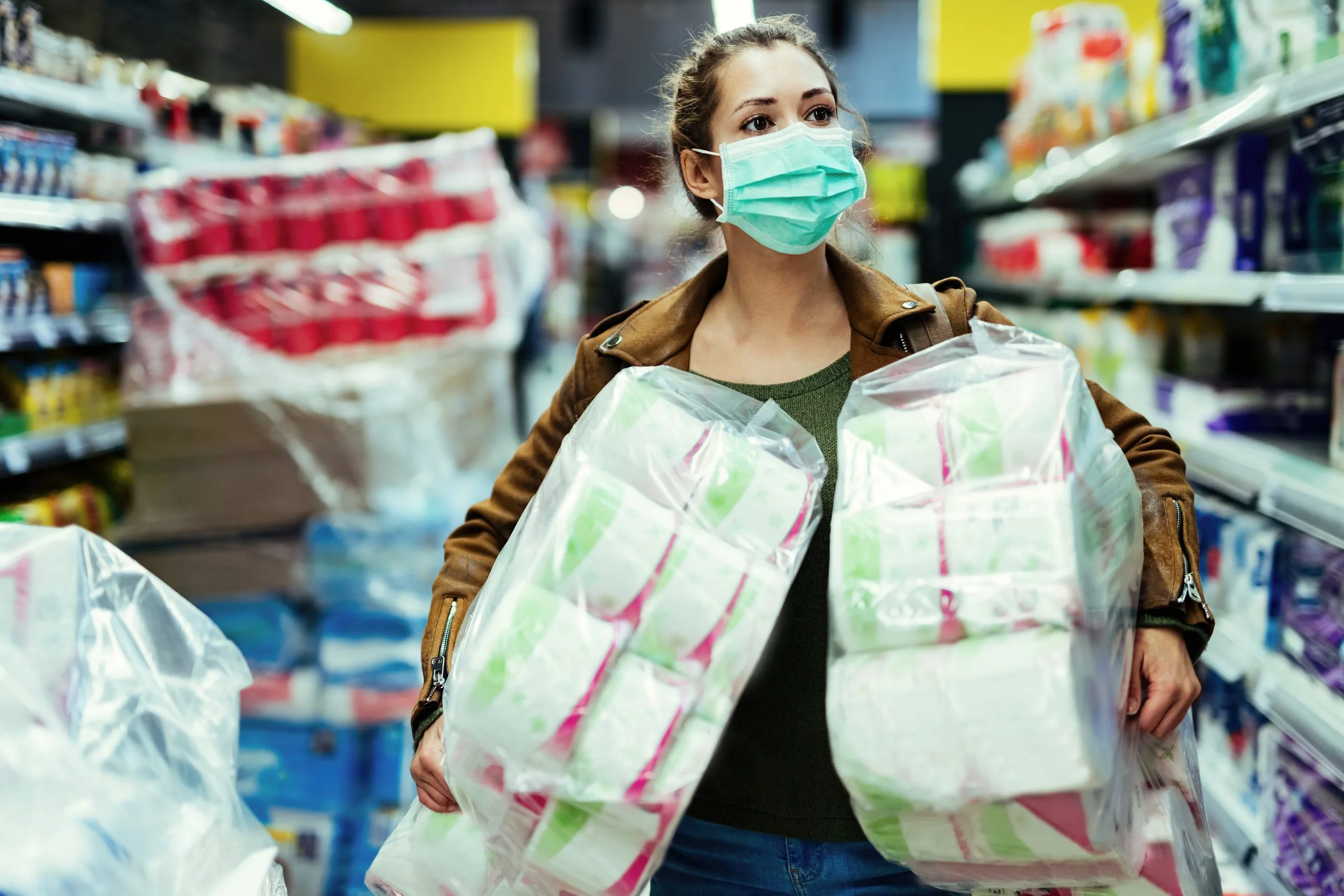 USA Adult Diaper Market Outlook to 2035 woman-wearing-protective-face-mask-while-carrying-packages-toilet-paper-buying-time-virus-pandemic-scaled
