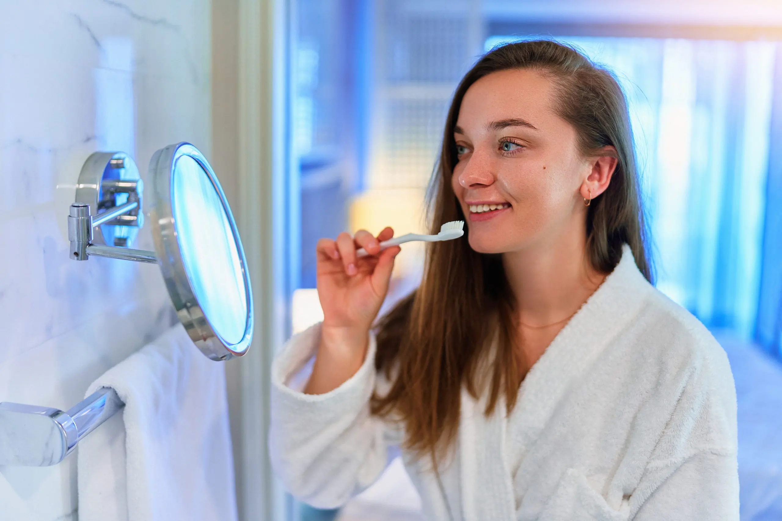 USA Teeth Whitening Market Outlook to 2035 young-beautiful-happy-girl-wearing-soft-white-bathrobe-brushing-her-teeth-bathroom-care-oral-health-scaled