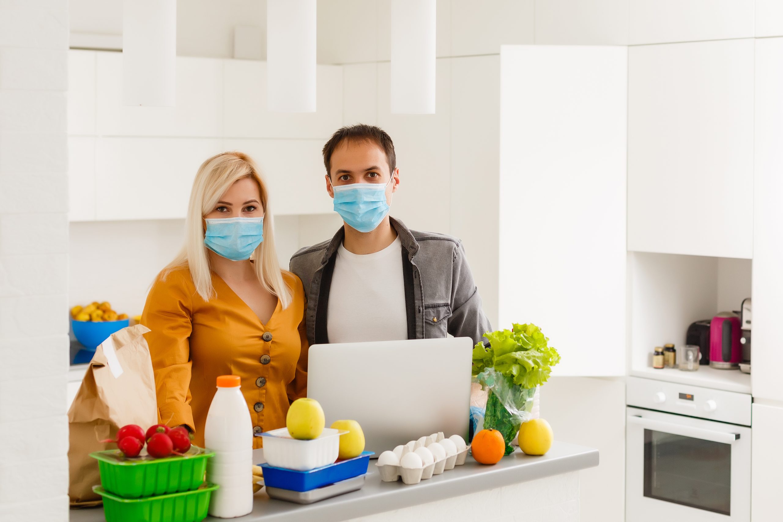 young-caucasian-couple-protective-masks-doing-shoppings-home-quarantine-scaled