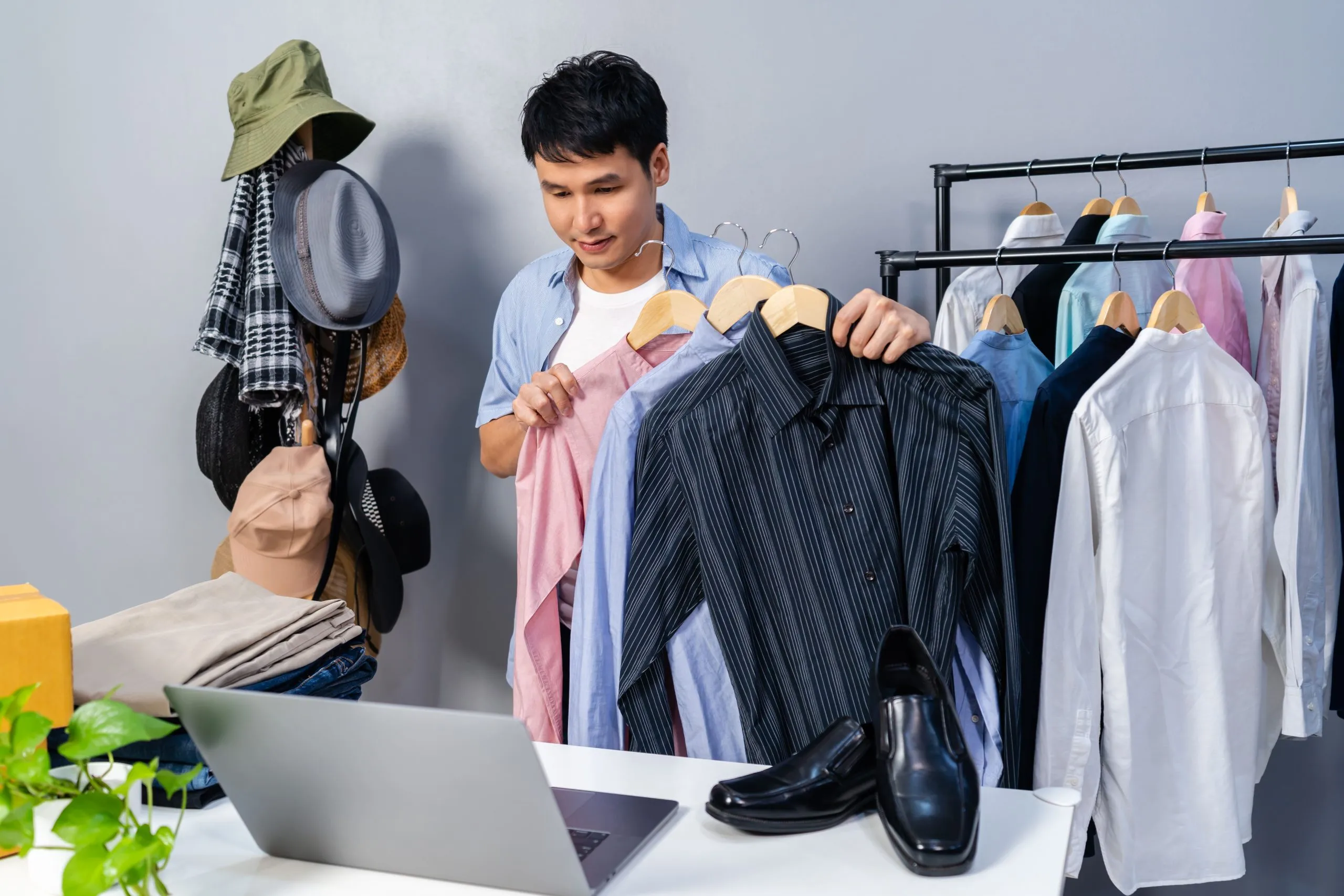 Philippines Online Clothing Rental Market Outlook to 2035 young-man-selling-clothes-accessories-online-by-laptop-computer-live-streaming-business-online-e-commerce-home-1-scaled