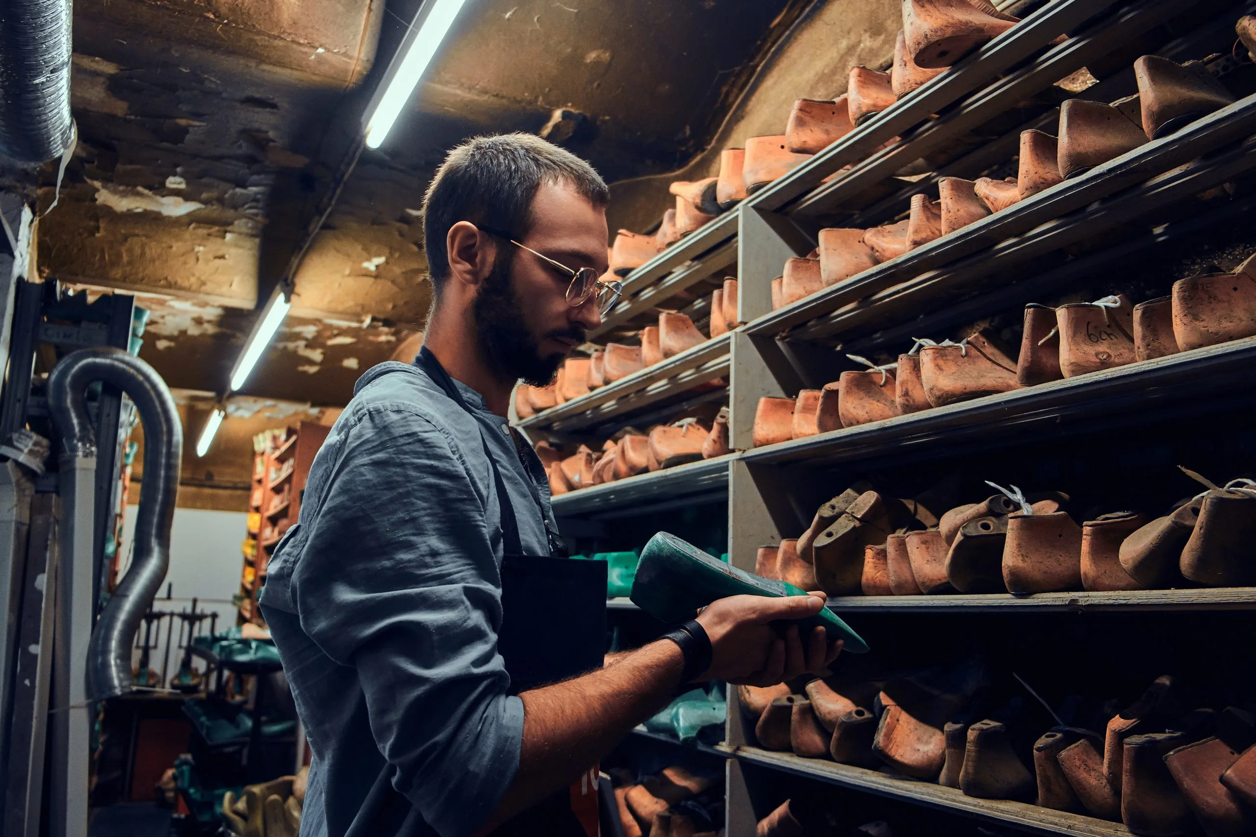 UAE Industrial Protective Footwear Market Gains Momentum as Safety Footwear Demand Grows at 6.7% CAGR value young-shoemaker-is-searching-special-shoe-form-his-new-project-scaled