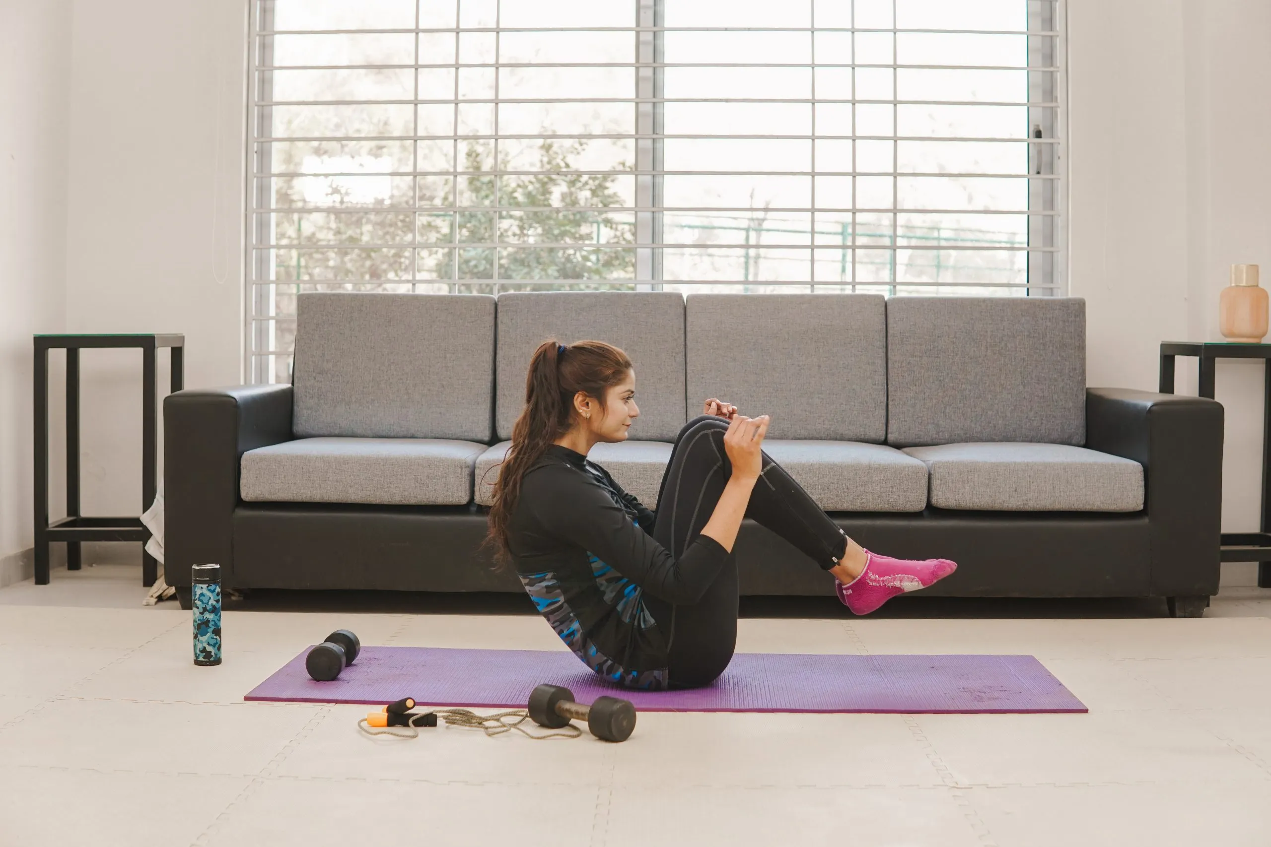 The Future of Fitness at Home in the Philippines with 60% of Consumers Using Smart Fitness Gear and Market Expansion young-woman-exercising-fitness-yoga-home-lifestyle-getting-active-lockdown-scaled
