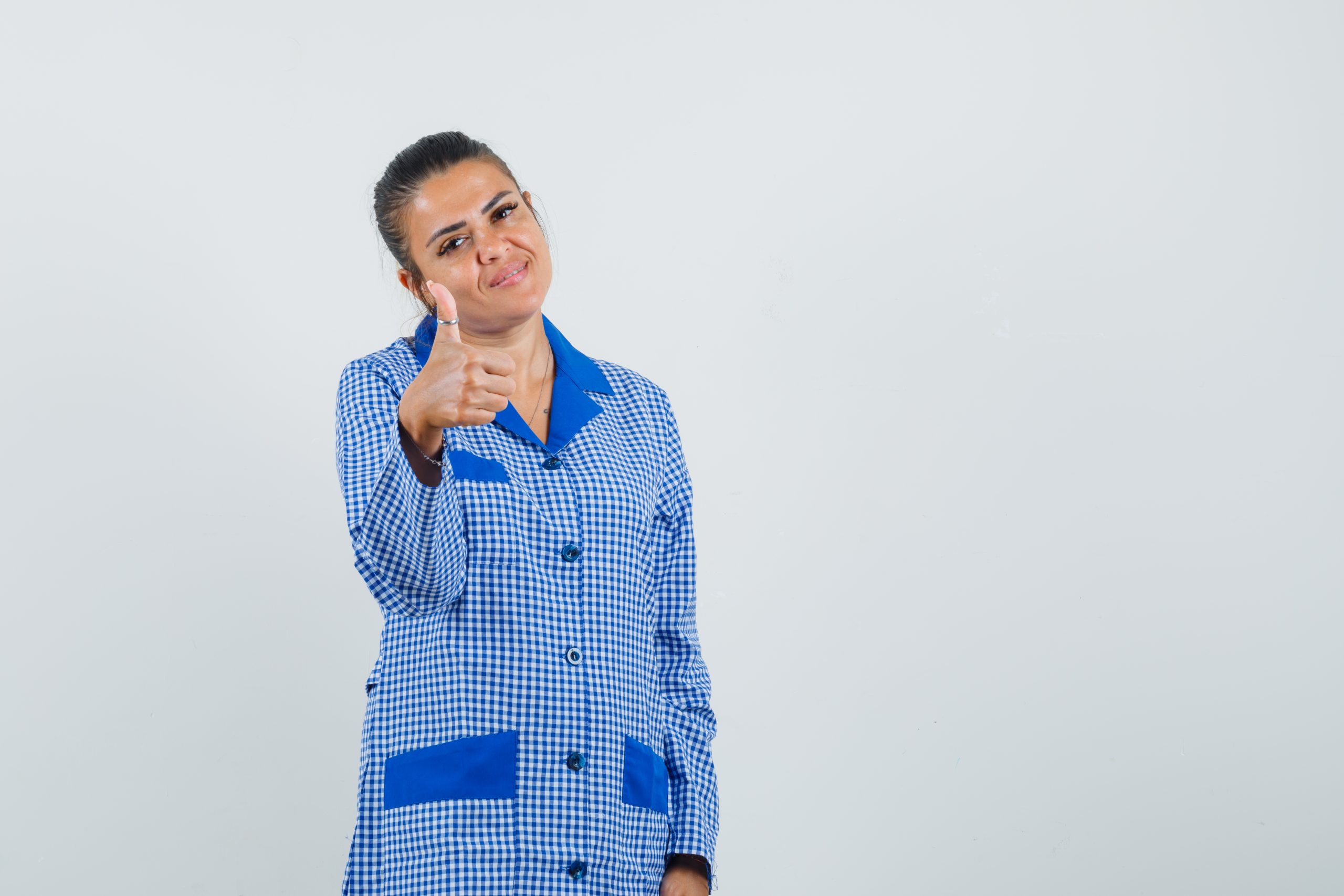 young-woman-showing-thumb-up-blue-gingham-pajama-shirt-looking-pretty-front-view-scaled