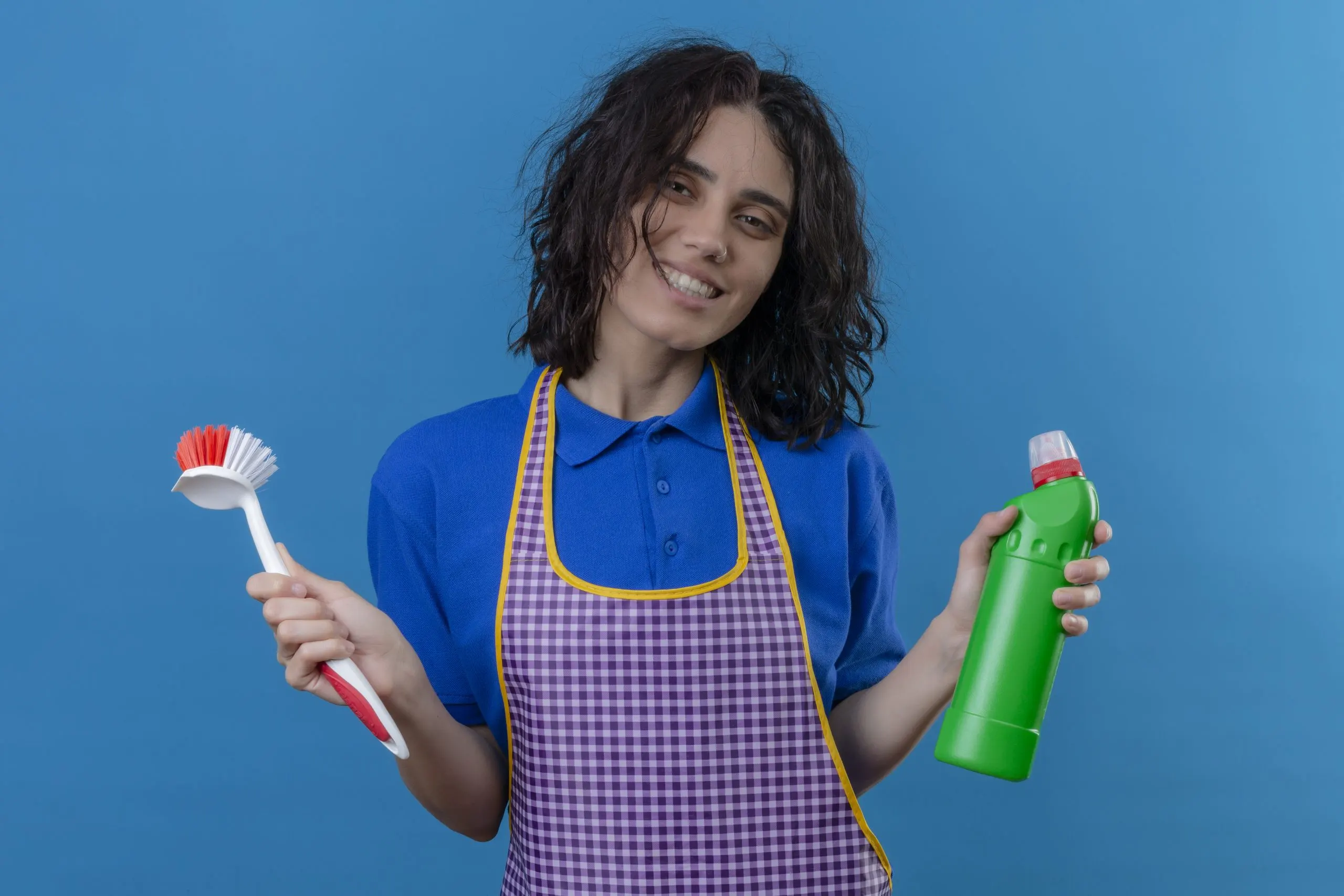 Brazil Household Cleaners Market Outlook to 2035 young-woman-wearing-apron-holding-scrubbing-brush-bottle-cleaning-supplies-smiling-cheerfully-looking-joyful-blue-wall-scaled
