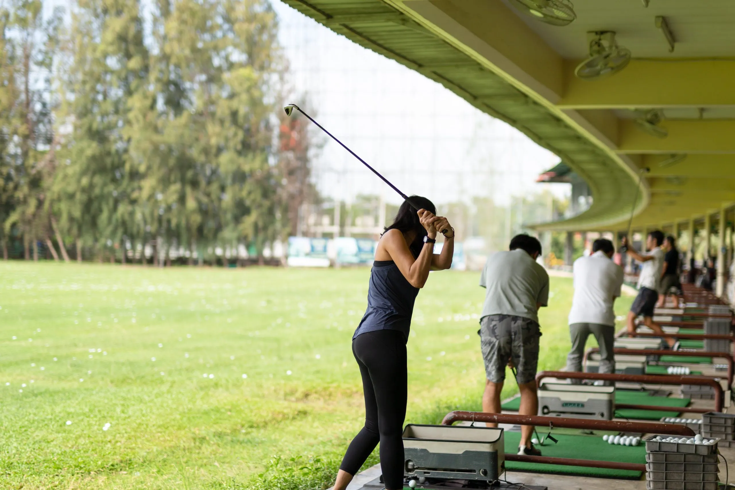 India Golf Equipment Market Growth Supported by USD 278.7 Million Market Size asian-woman-practicing-his-golf-swing-golf-driving-range-scaled