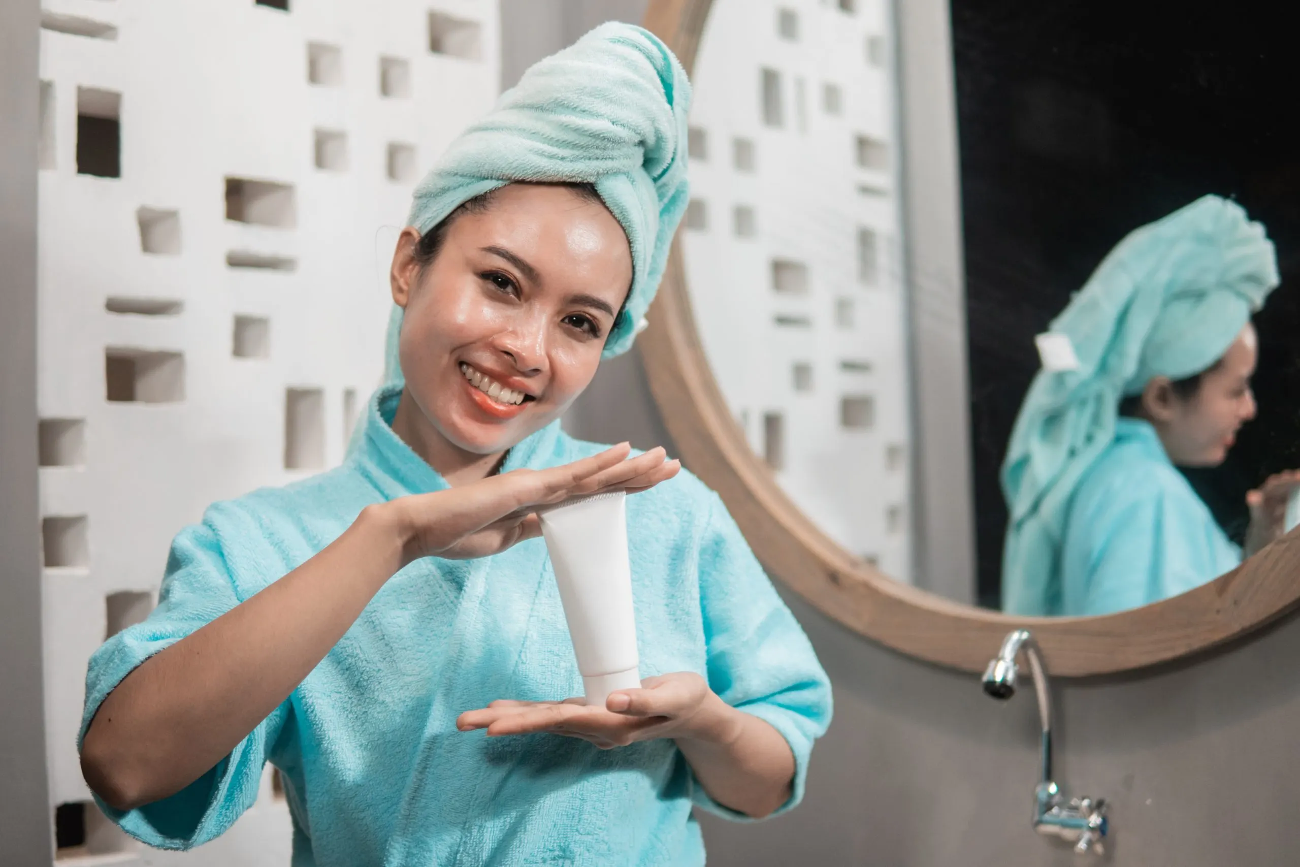 UAE Face Wash Market Surpasses USD 200 Million Driven by Premium Skincare Demand asian-woman-with-fresh-skin-holding-facial-treatment-cream-mockup-scaled