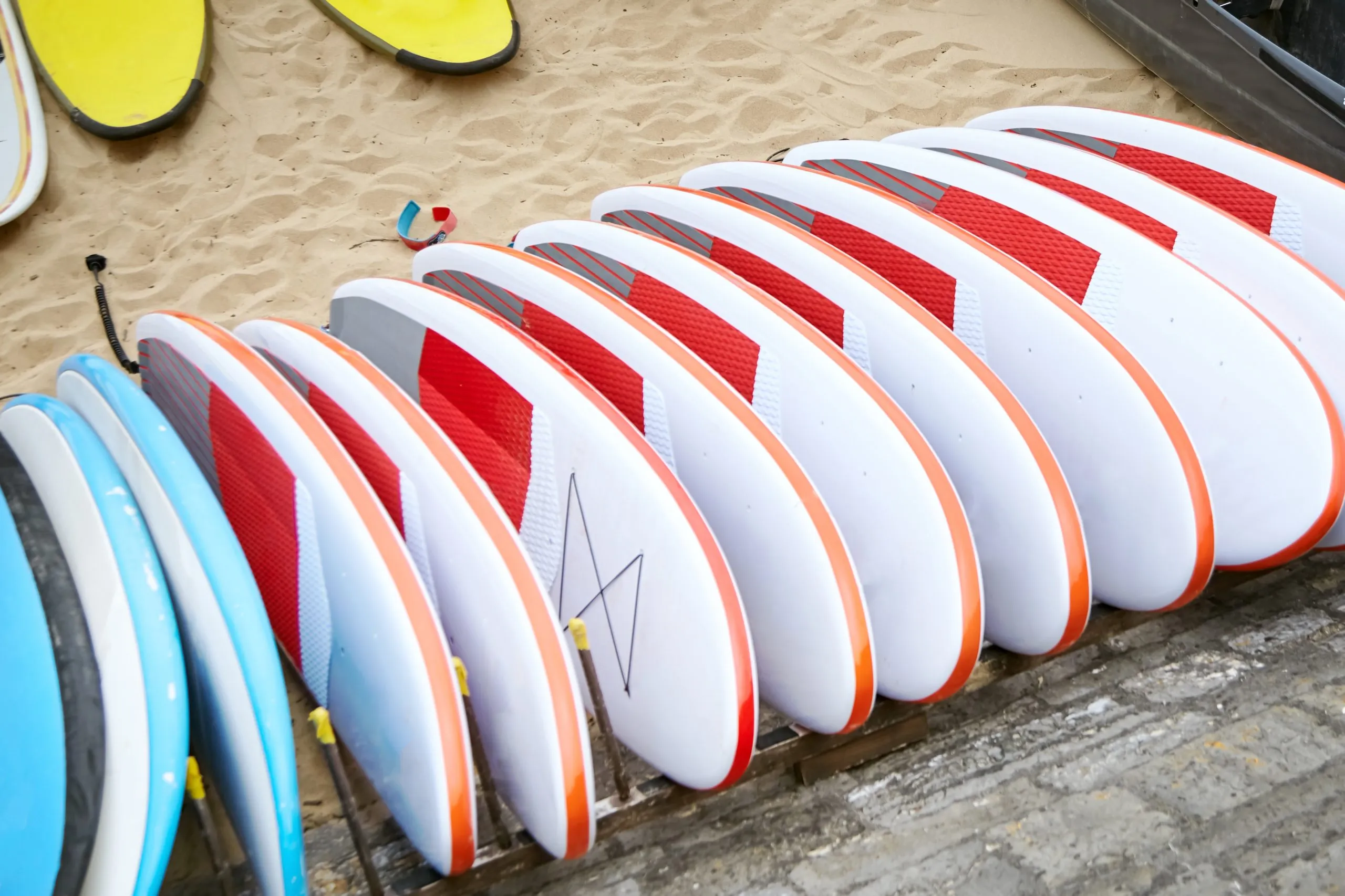 Nigeria Surfing Equipment Market Rides Growth Wave with Over 5 Percent Expansion many-surfboards-sandy-beach-scaled
