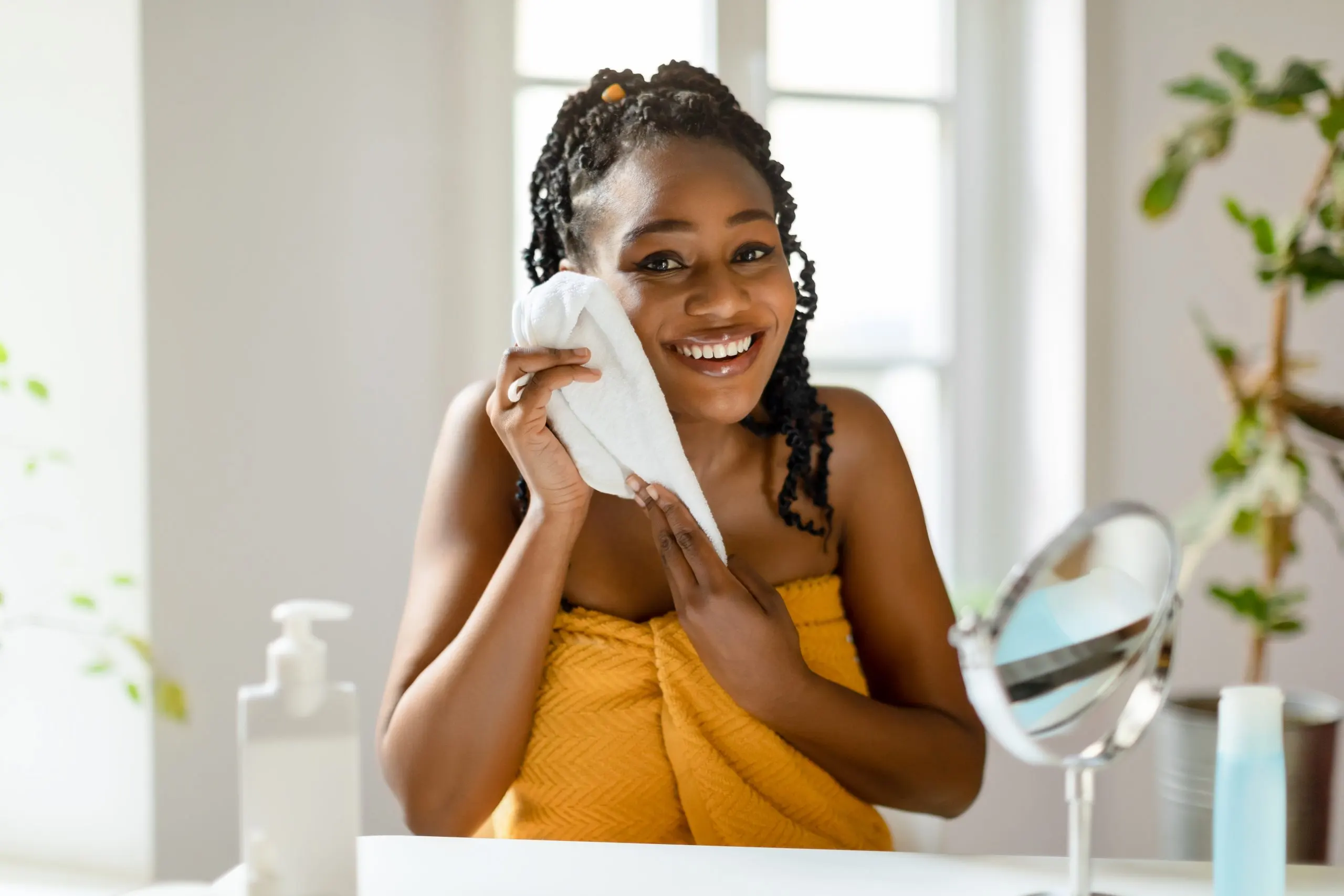 Nigeria Feminine Wipes Market Expands as Personal Care Spending Crosses 8 Billion Nationwide moment-skin-serenity-happy-black-lady-drying-clean-face-with-towel-after-shower-sitting-scaled