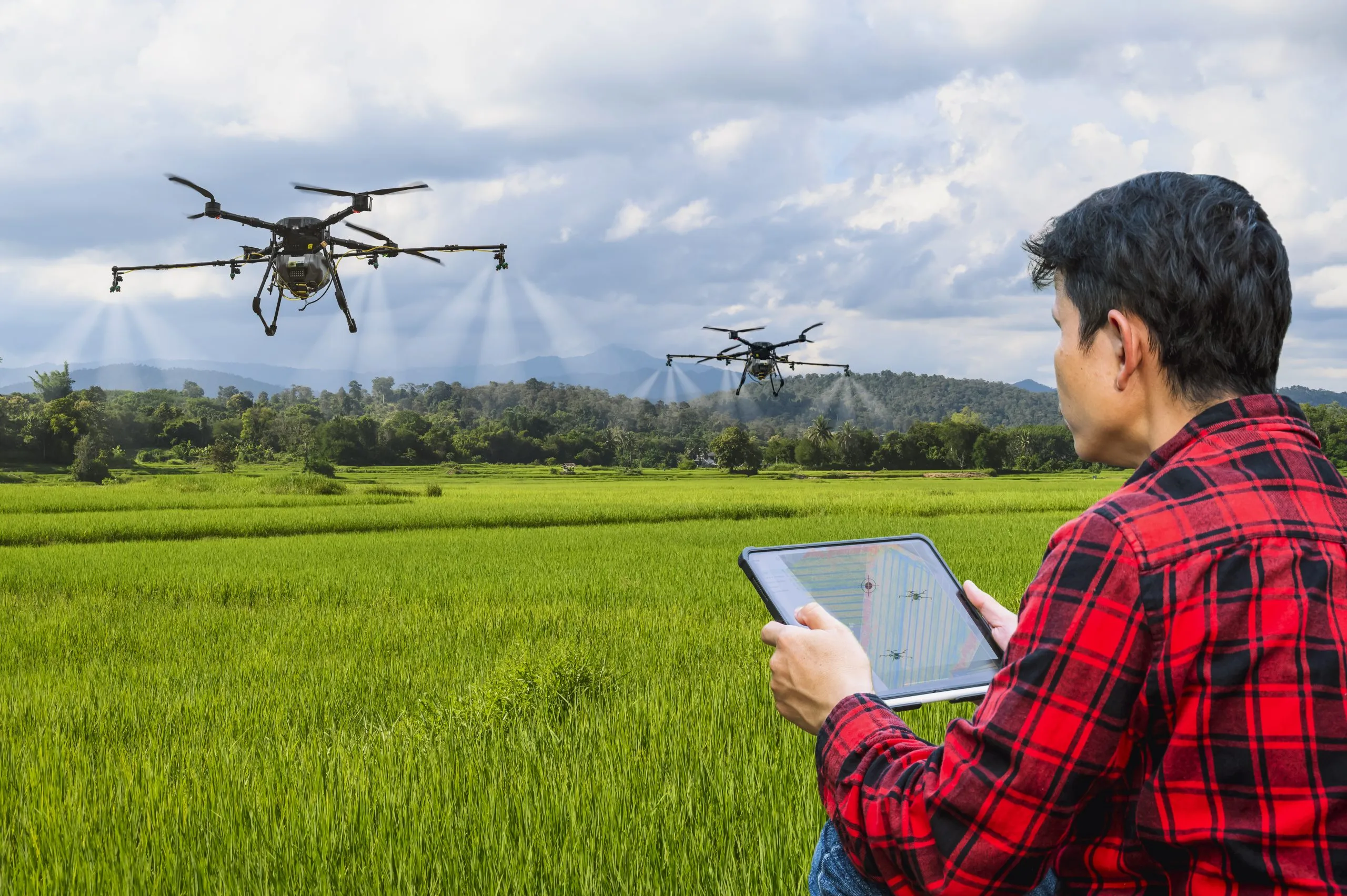 Philippines Agriculture Drones and IoT Sensors Market Expands as Farm Efficiency Improves by 30 Percent smart-farmer-using-tablet-control-agriculture-drone-farming-fly-spray-fertilizer-insecticide-rice-fieldsasian-smart-farm-concept-scaled