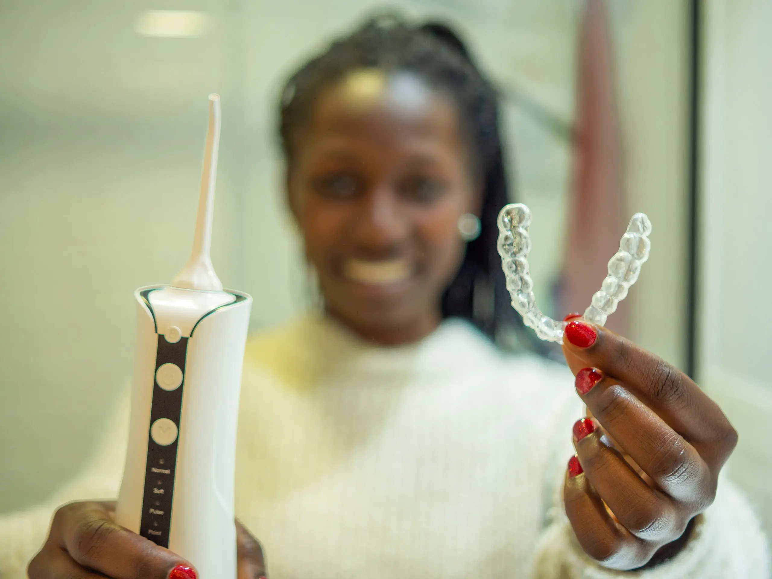 South Africa Teeth Whitening Market Gains Momentum Within USD 524 Million Oral Care Industry young-woman-showing-her-domestic-dental-water-flosser-her-dental-aligner-scaled