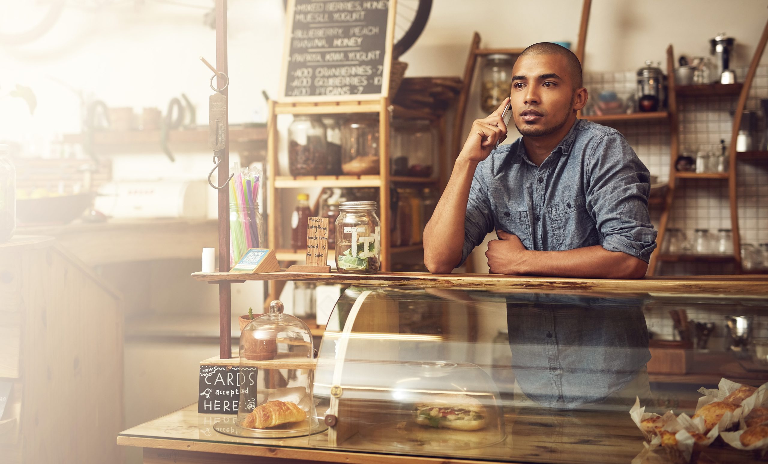 Nigeria Cafes and Bars Market Driven by 139 Million Internet Subscribers and Growing Digital Ordering Trends phone-call-listening-man-cafe-conversation-communication-with-supplier-order-stock-talking-entrepreneur-person-with-mobile-chat-planning-delivery-small-business-scaled